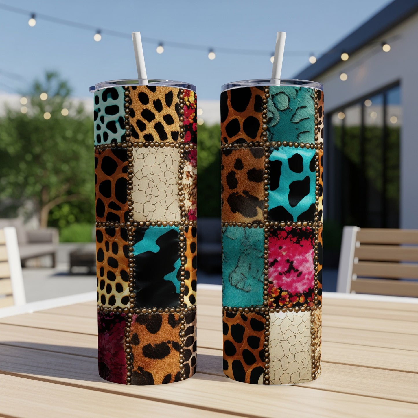 Two tumblers with patchwork animal print designs sit on a table outdoors.
