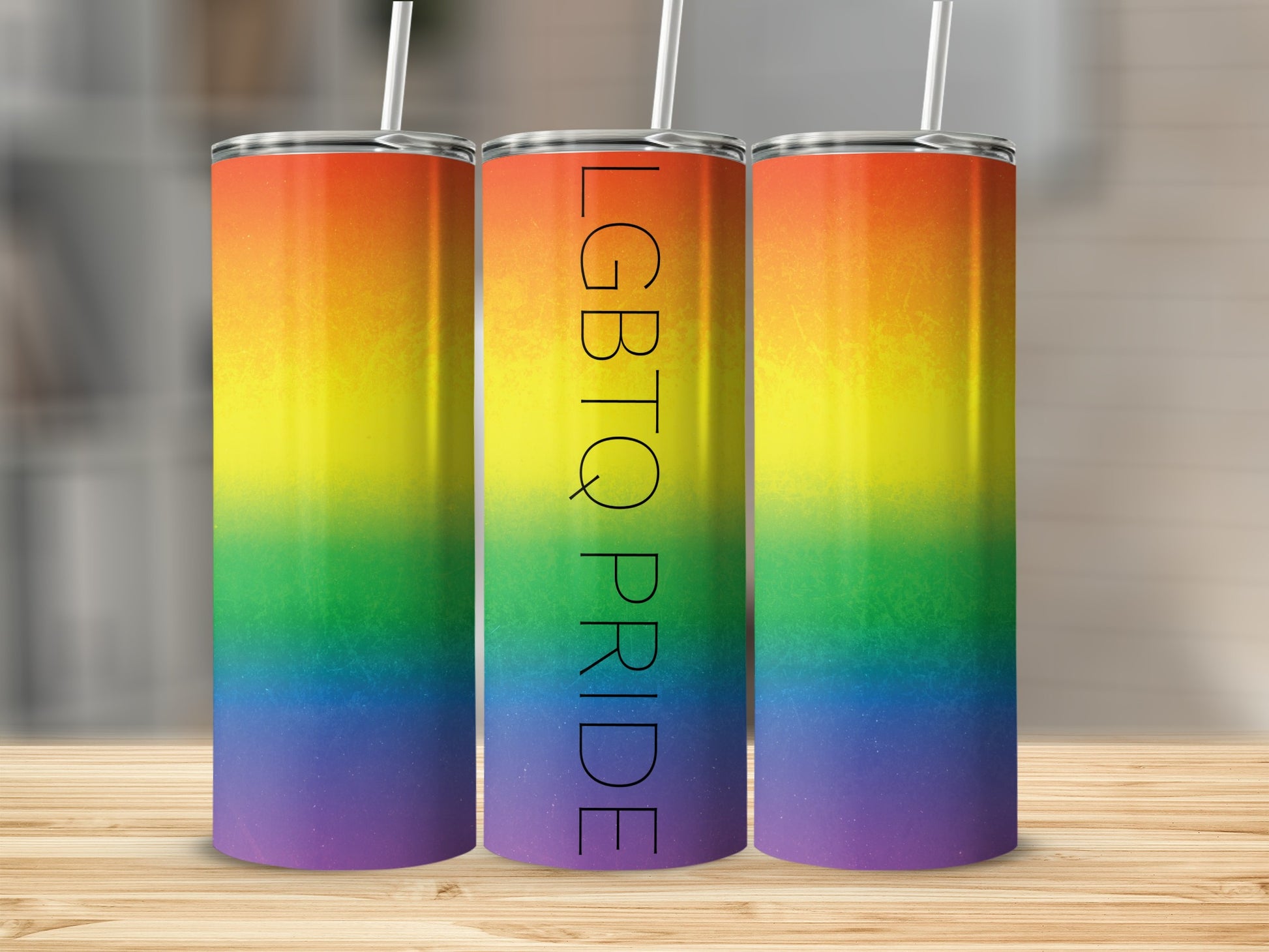 Three tall tumblers with LGBTQ+ pride rainbow gradient design.