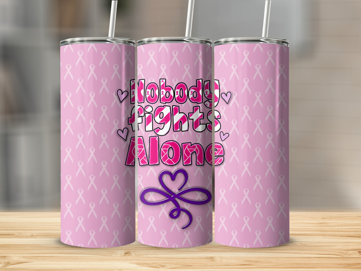 Pink tumbler with "Nobody Fights Alone" and pink ribbon pattern.