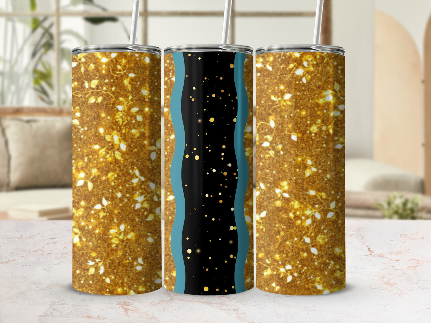 Three tumblers with gold glitter and floral designs.