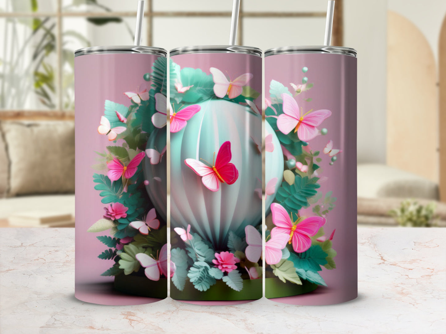Pink butterflies and green foliage around a teal orb on three tumblers.