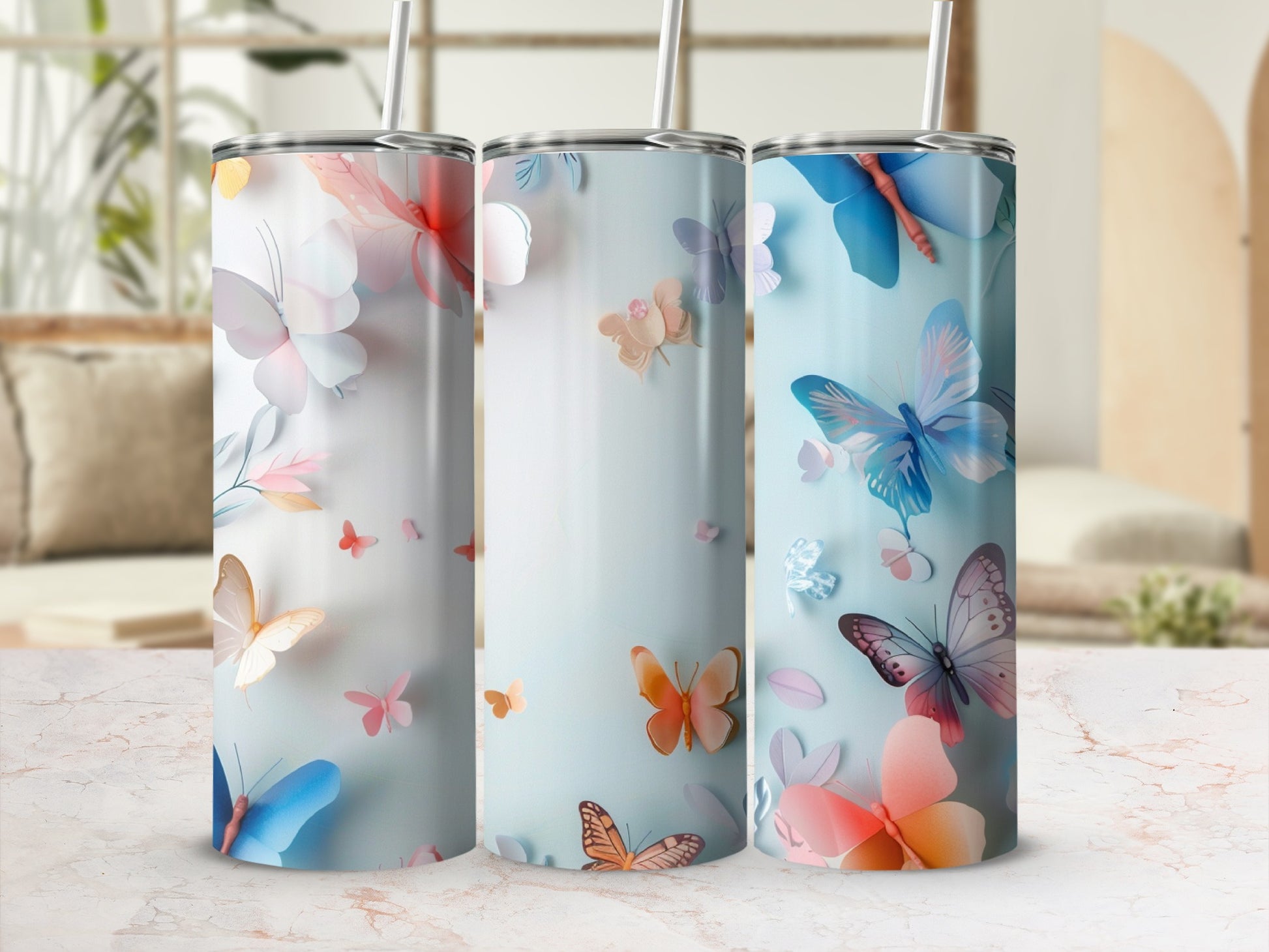Three tumblers with delicate butterfly and floral designs.