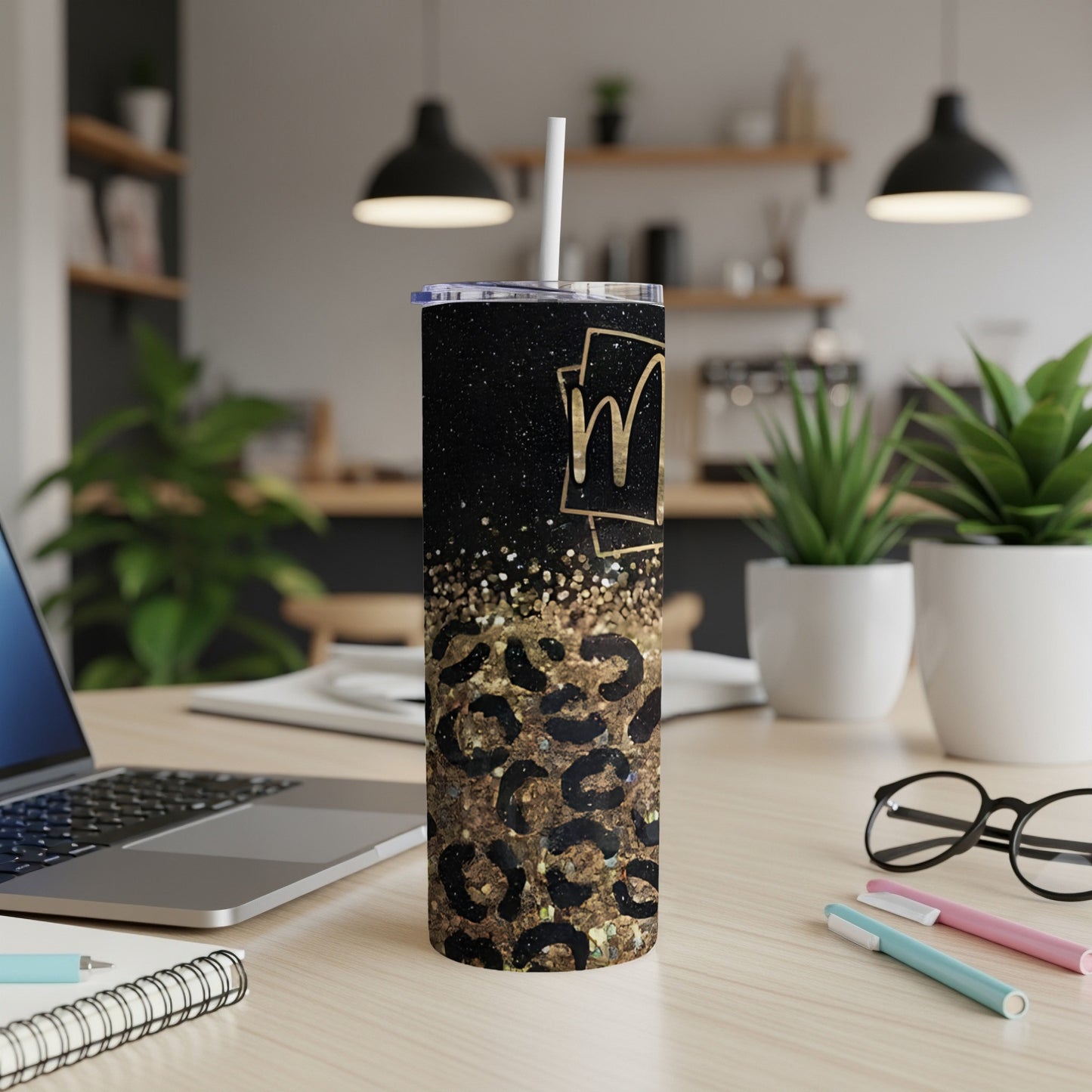 Black glitter tumbler with leopard print and gold "M" monogram.
