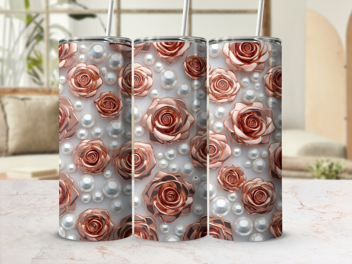 Rose and pearl pattern on three rose gold tumblers with straws.
