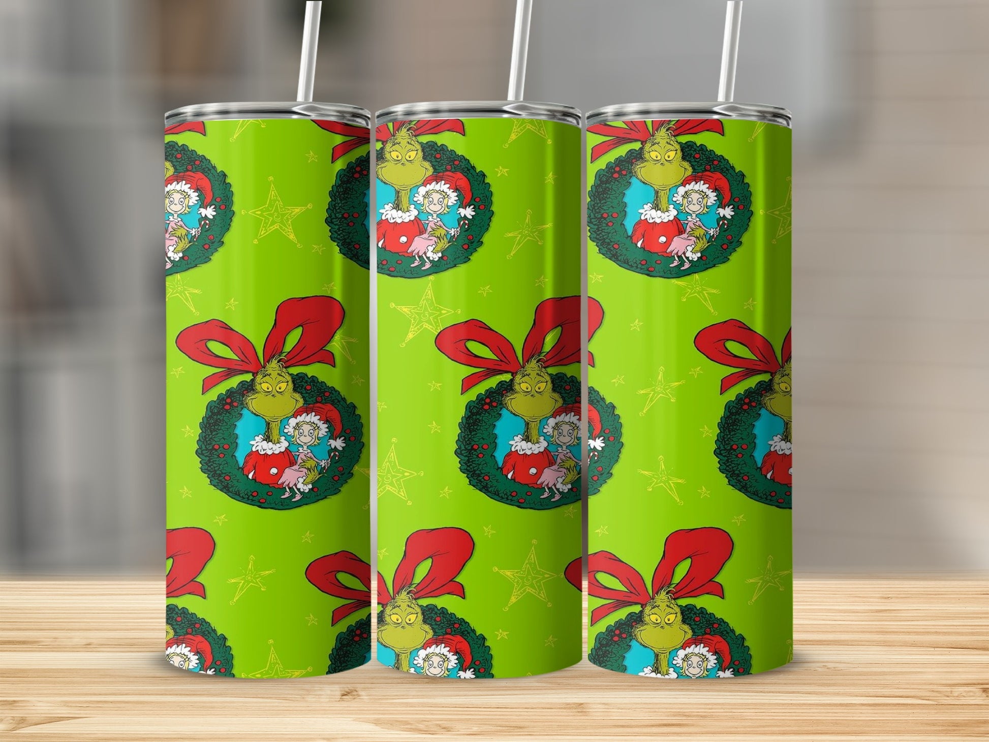 Three green tumblers with Grinch and Cindy Lou Who holiday pattern and red bows.