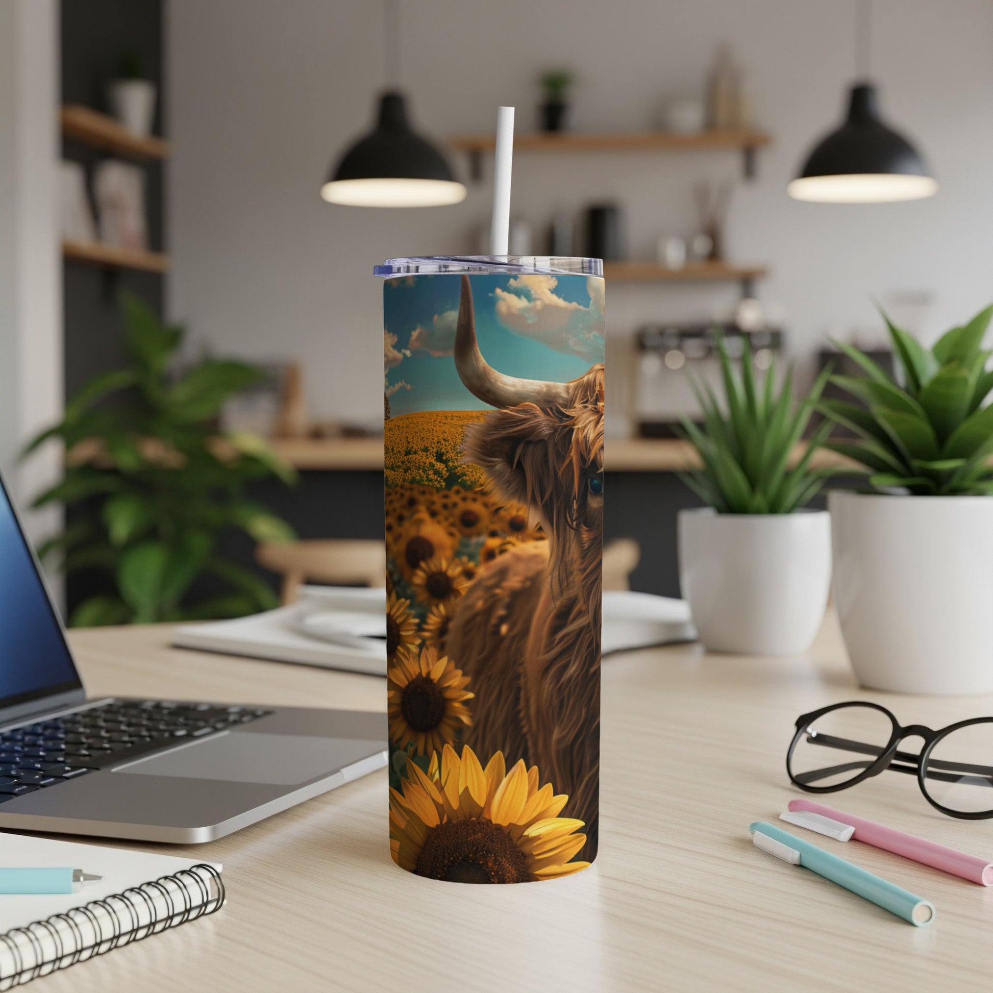 Highland cow in a sunflower field on a blue sky tumbler.