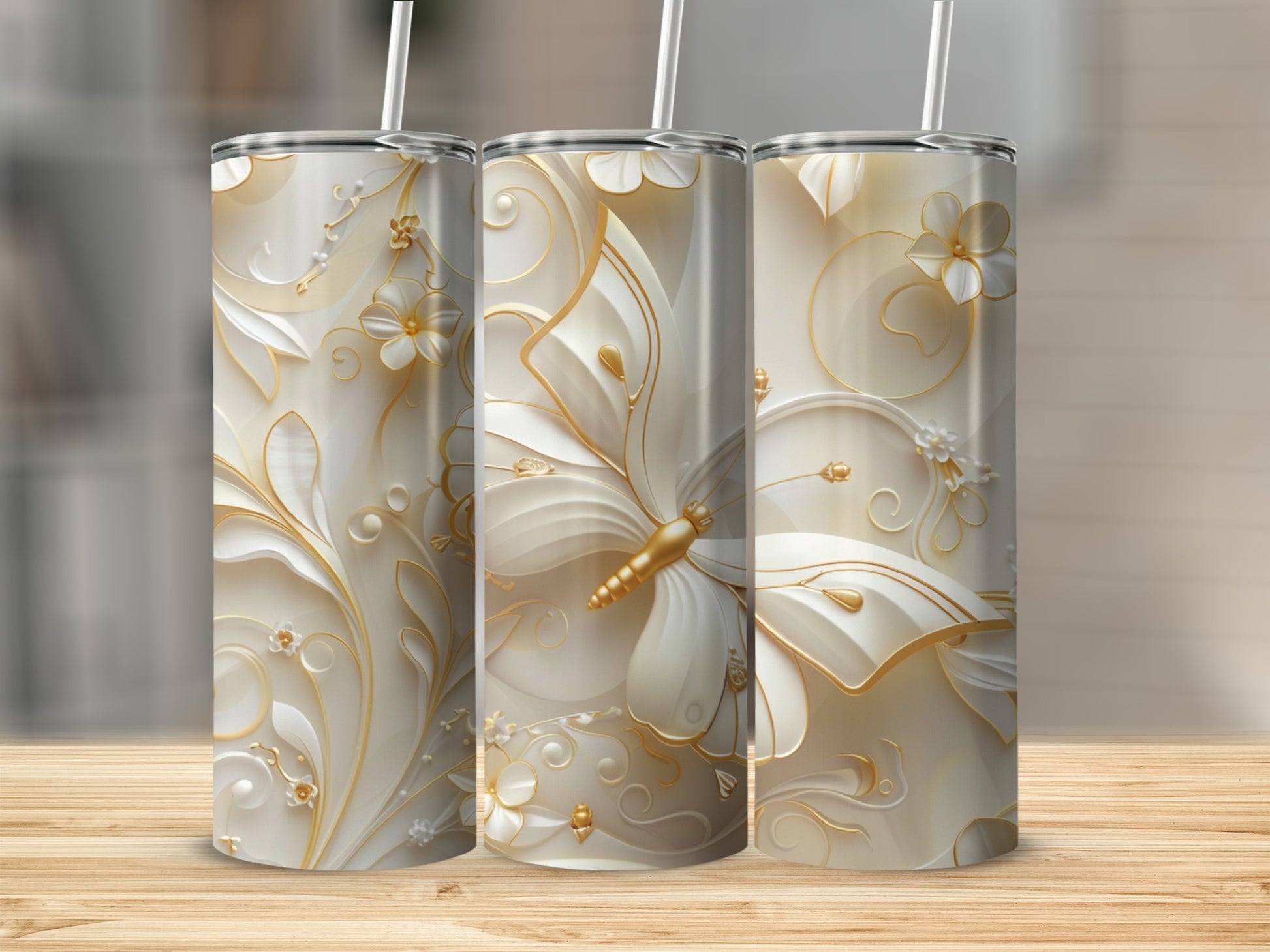 Three tall tumblers with white and gold floral and butterfly embossed designs.