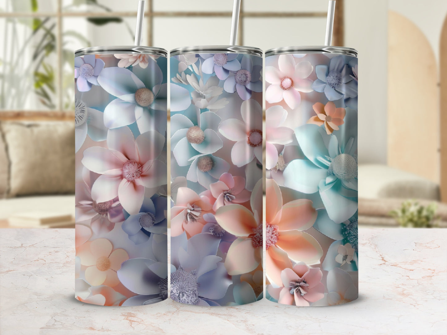 Three tumblers with floral patterns in pastel colors and straw.