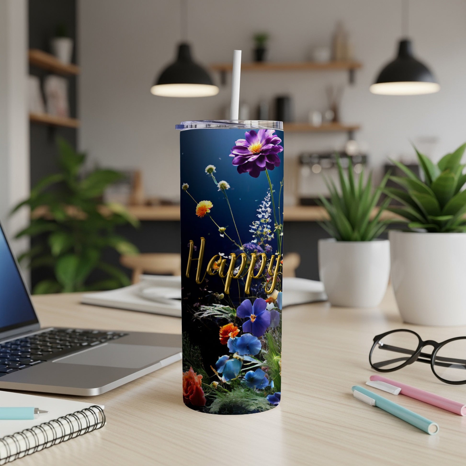 Tumbler with "Happy" text and colorful floral design, placed on a desk.