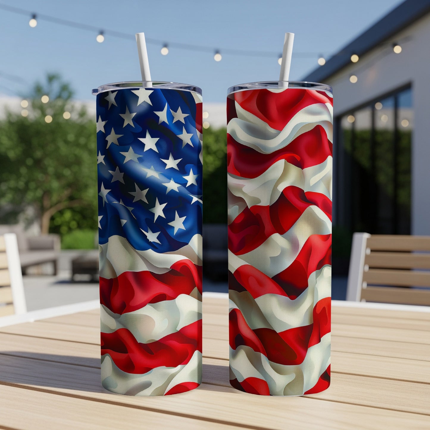 Two American flag pattern tumblers with straws on a table.
