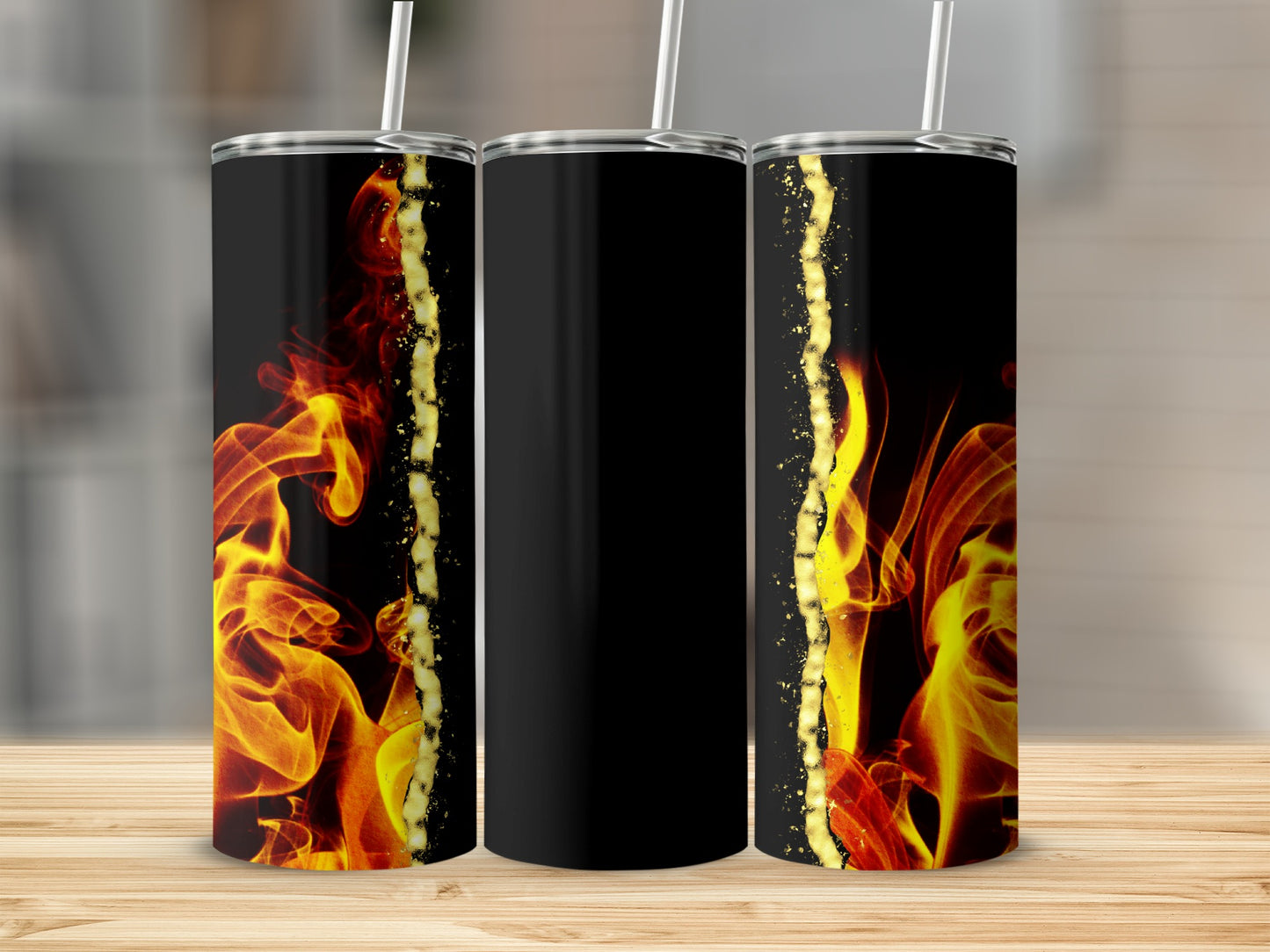 Three black tumblers with gold glitter and fiery red and yellow flames.