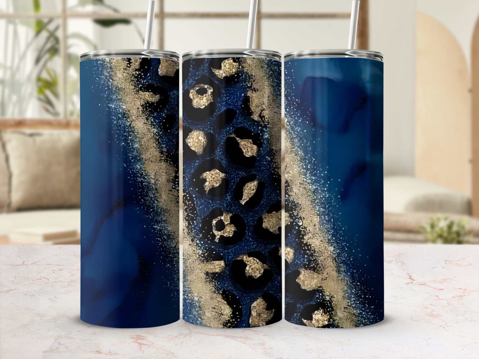 Three tumblers with dark blue and gold leopard print designs.