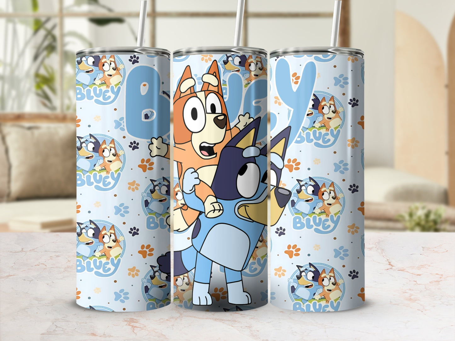 Bluey and Bingo characters on a pale blue tumbler with blue paw prints.