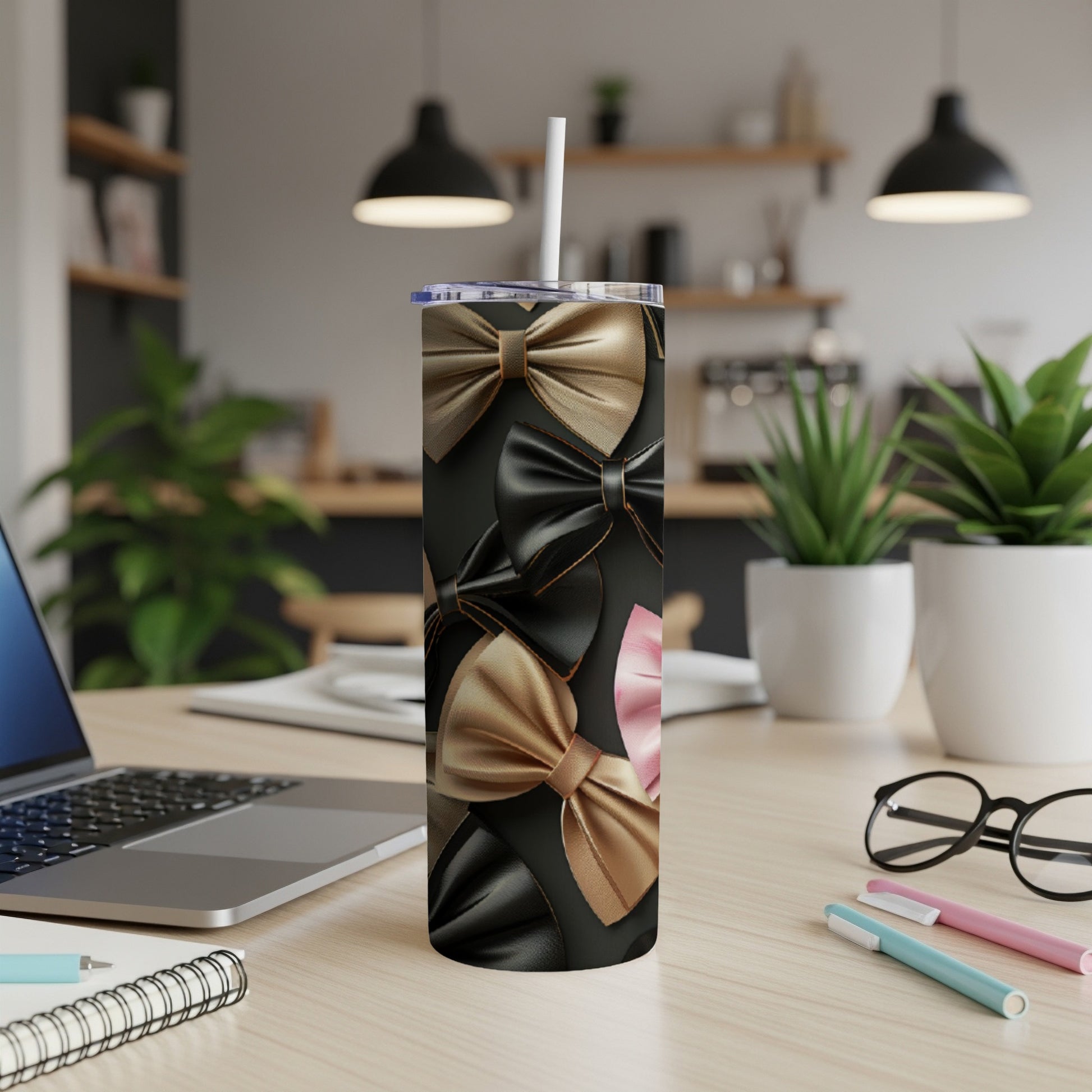Black tumbler with a pattern of satin bows in gold, beige, and pink.