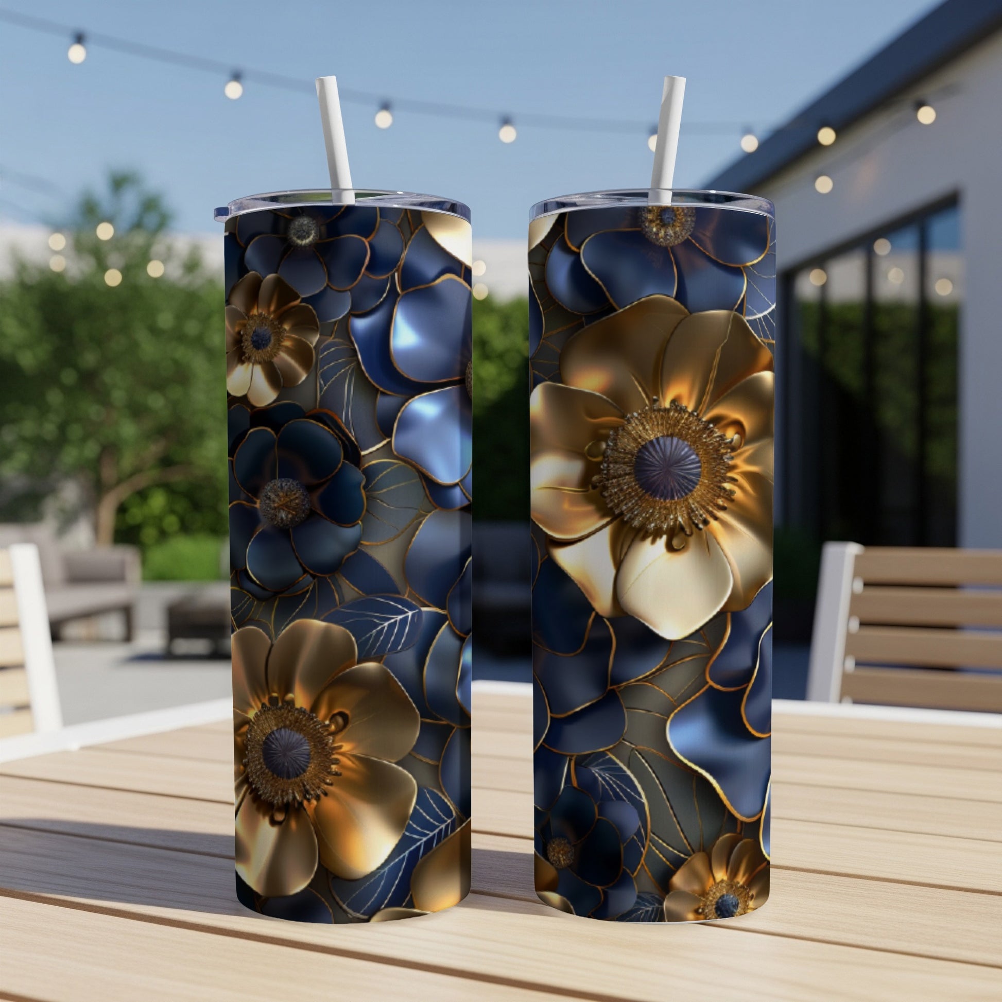 Two tumblers with dark blue and gold floral patterns on a table.