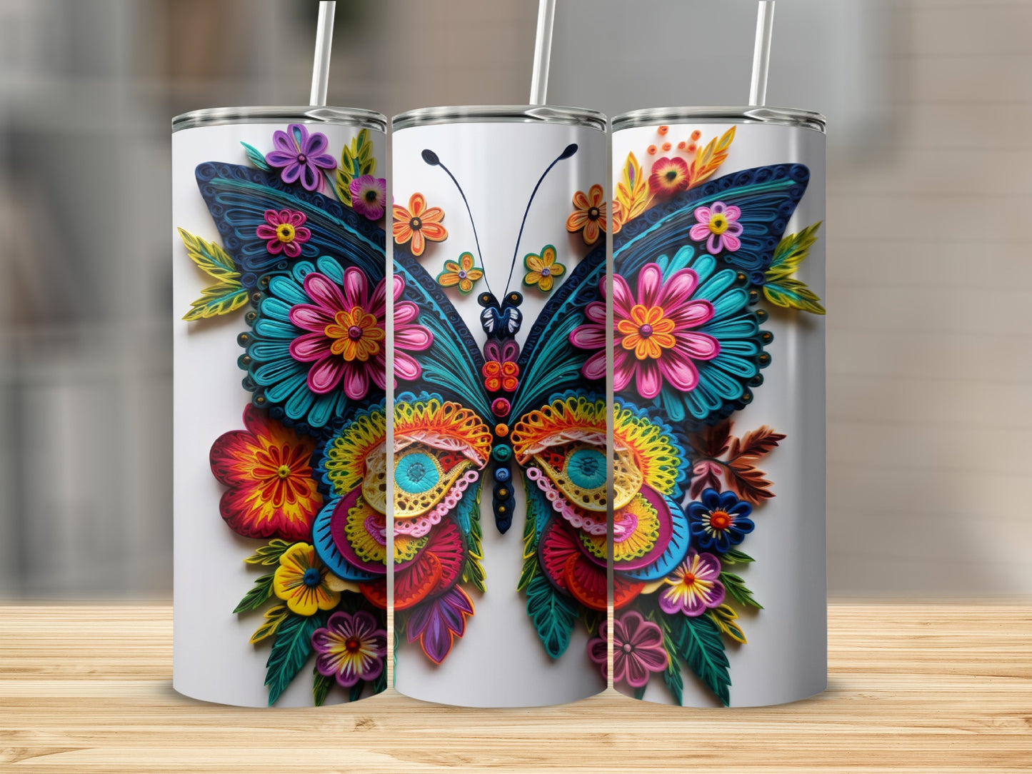 Three tumblers featuring a colorful butterfly design with floral accents.
