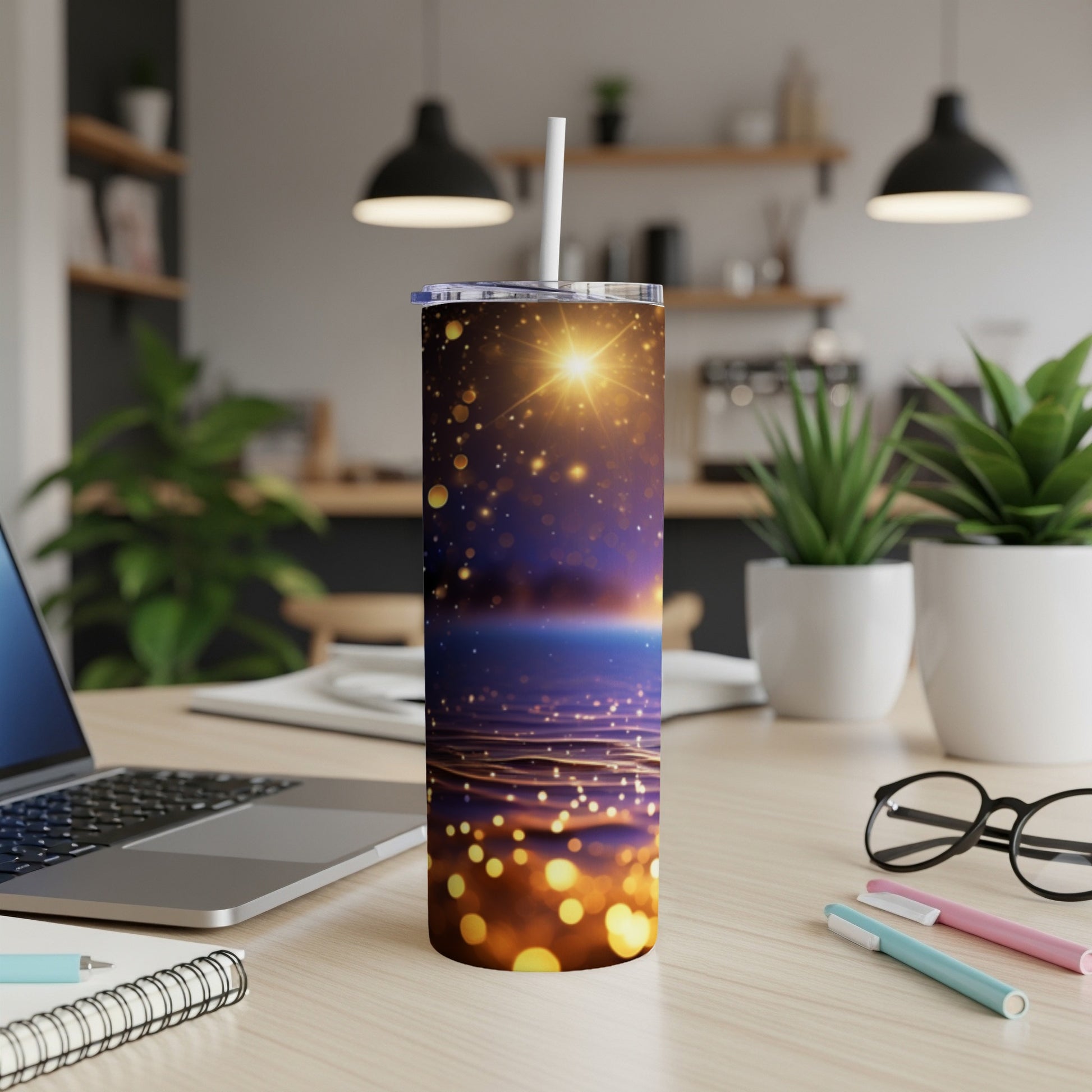 Glittering galaxy design on a white tumbler with a straw.