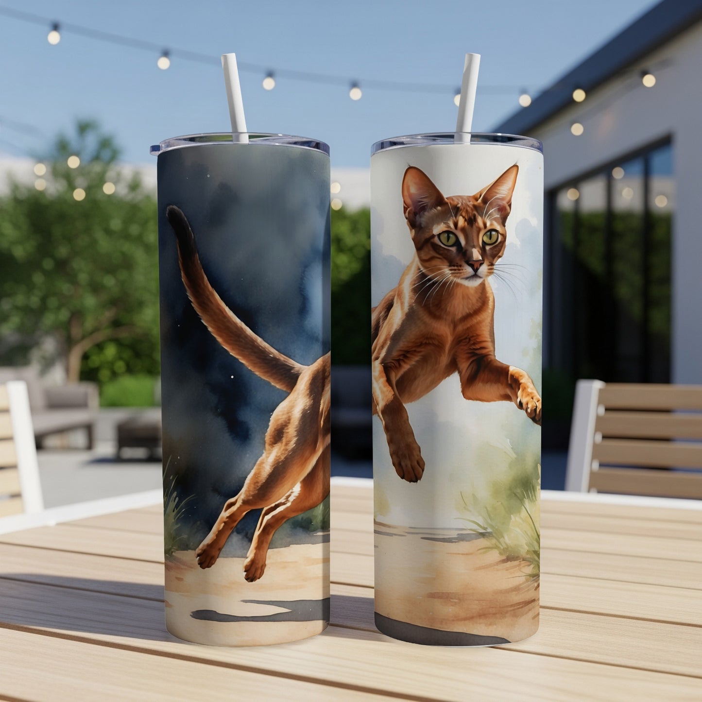 Two Abyssinian cats depicted mid-leap on separate tumblers.