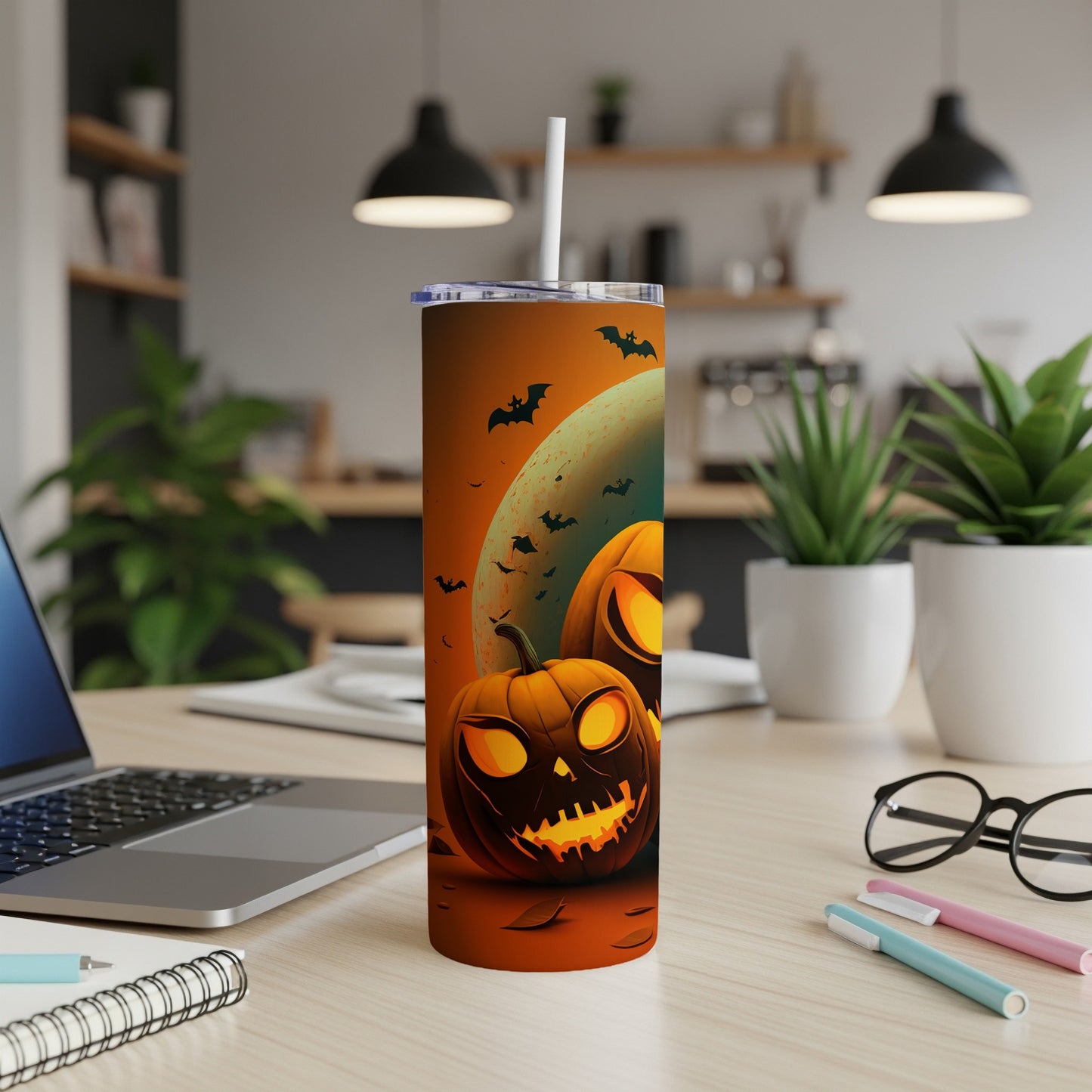 Tall tumbler with glowing jack-o'-lanterns and bats against an orange moon backdrop.