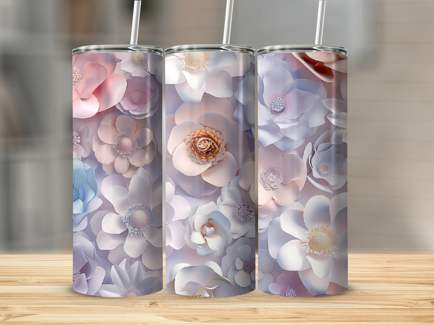 Three tumblers with delicate floral designs in pastel colors.