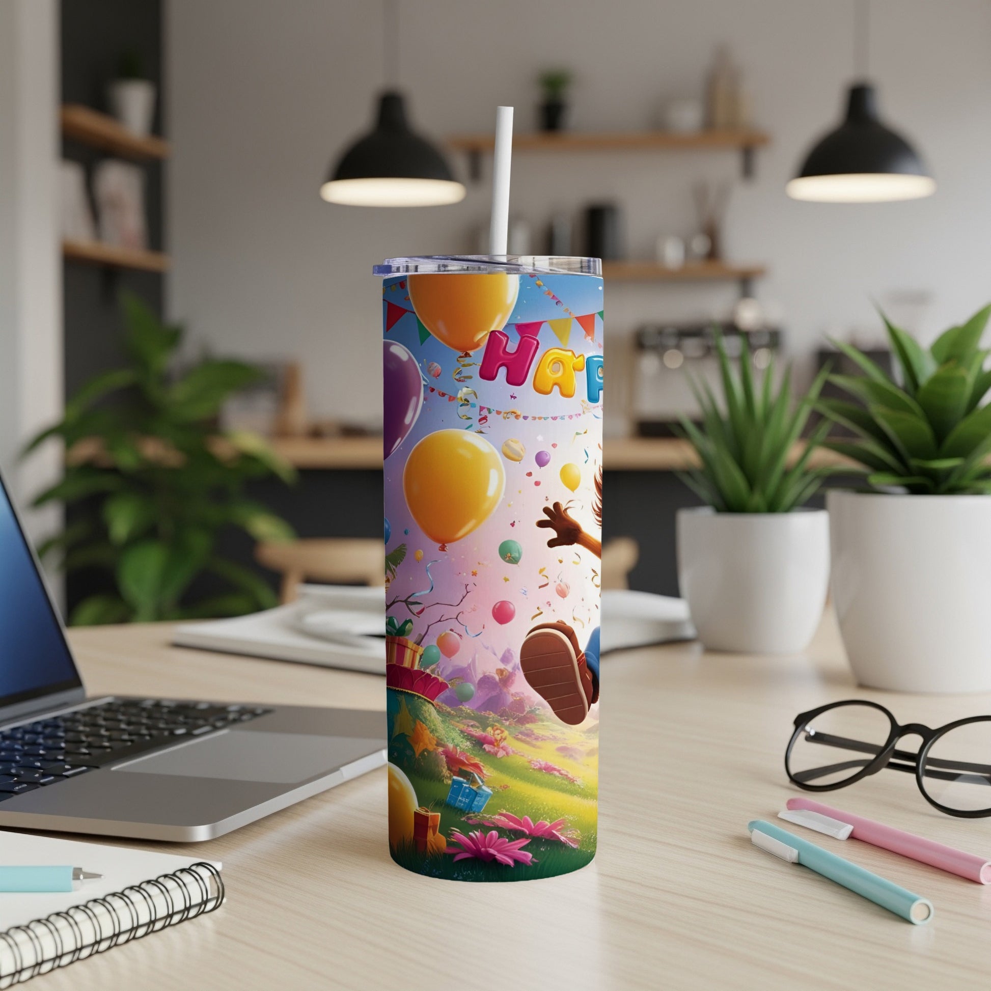 Birthday tumbler with balloons, confetti, and cartoon characters on a grassy hill.