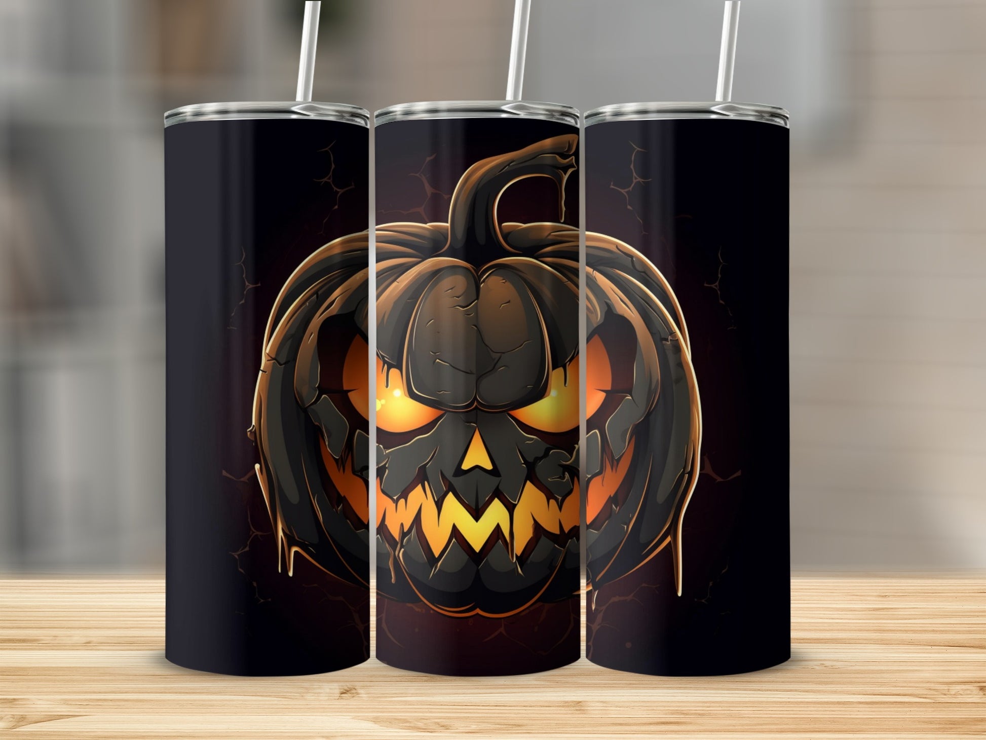 Three tumblers featuring a menacing jack-o'-lantern design with glowing orange eyes and mouth.