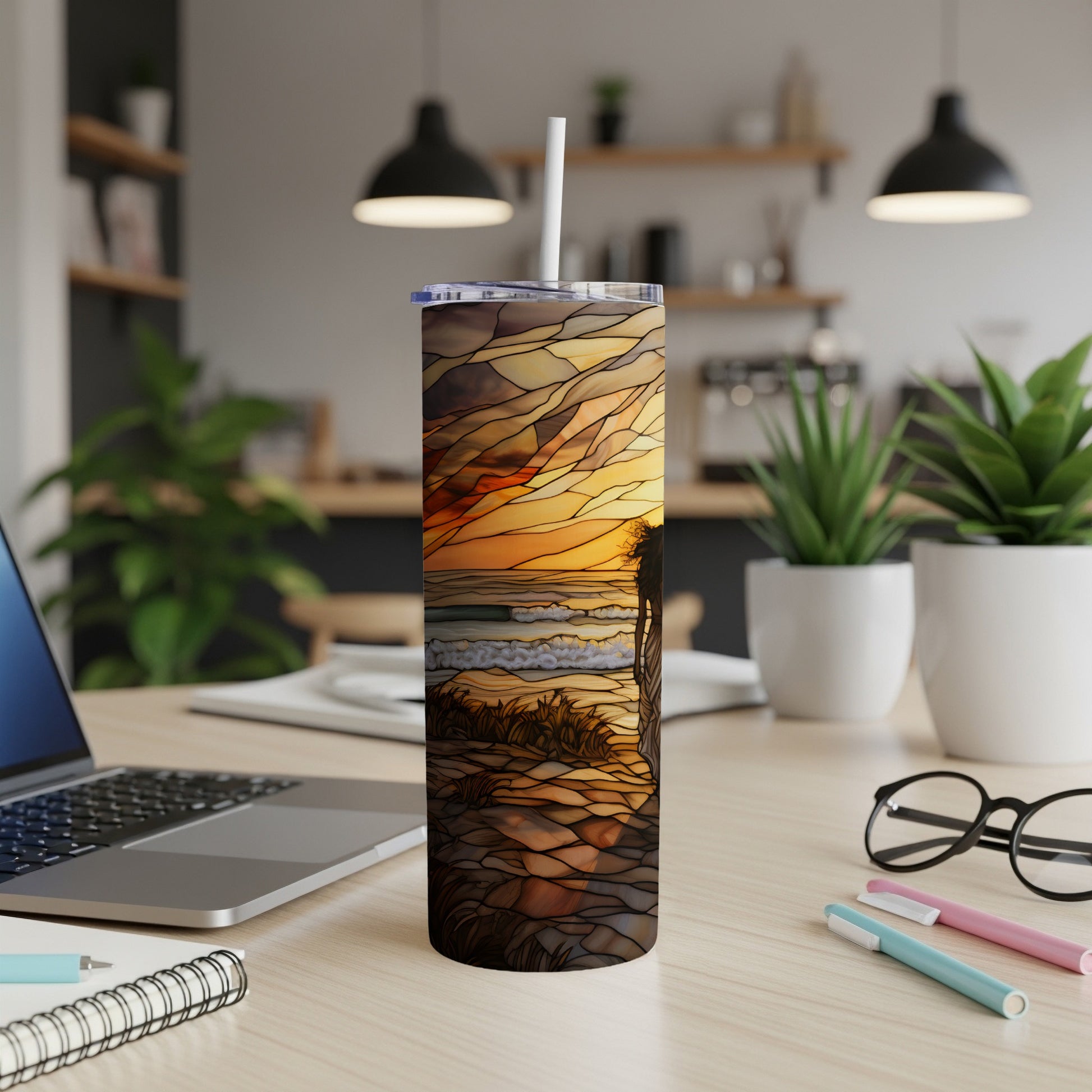 Sunset beach scene on a white tumbler with a straw.