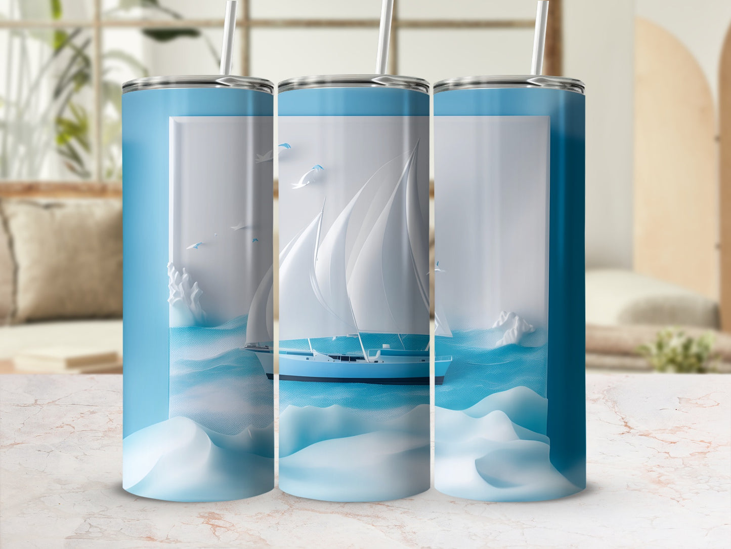 Three blue tumblers with a sailboat graphic and ocean waves.