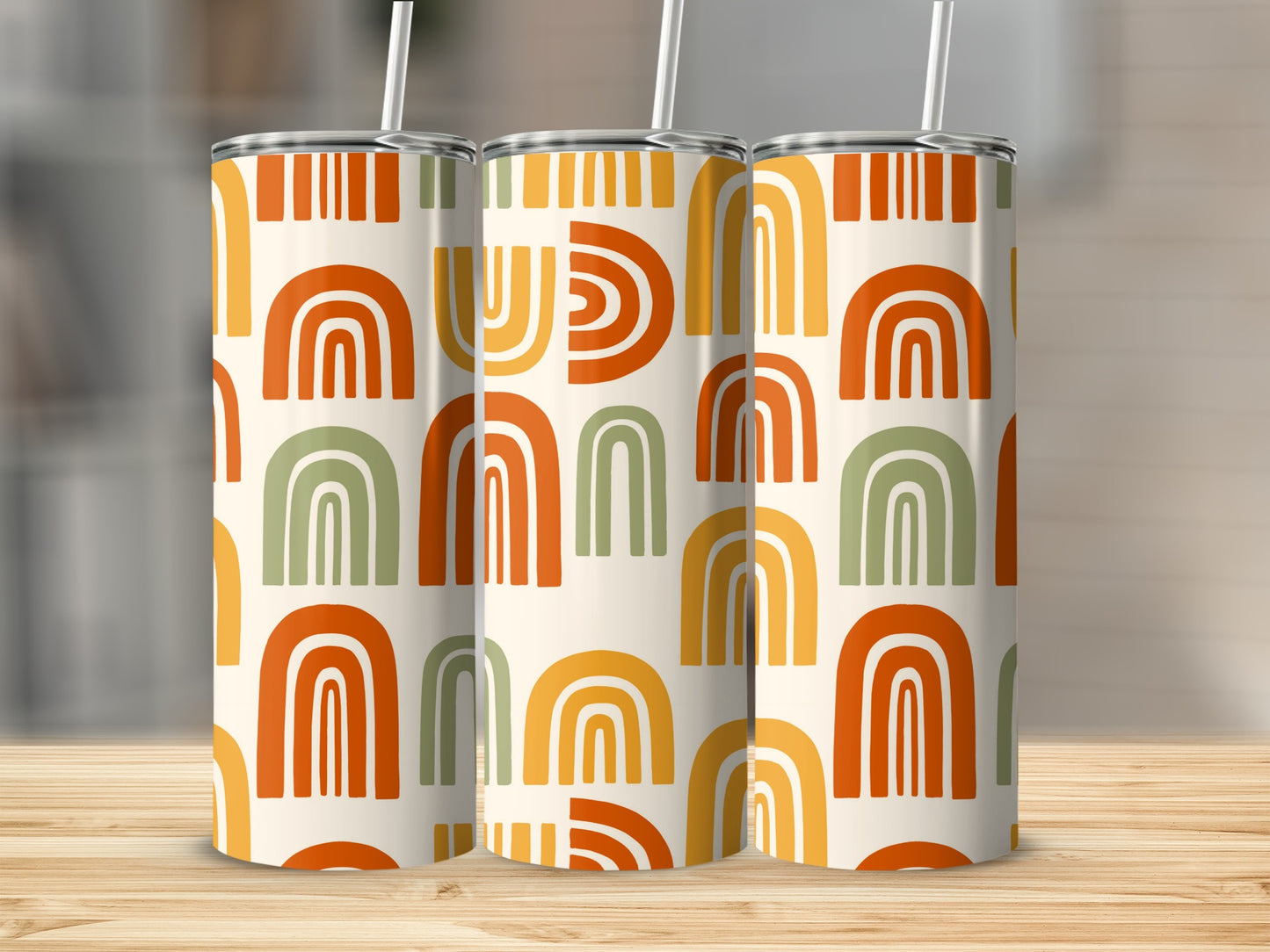Three tumblers with a boho rainbow pattern in cream, orange, yellow, and green.