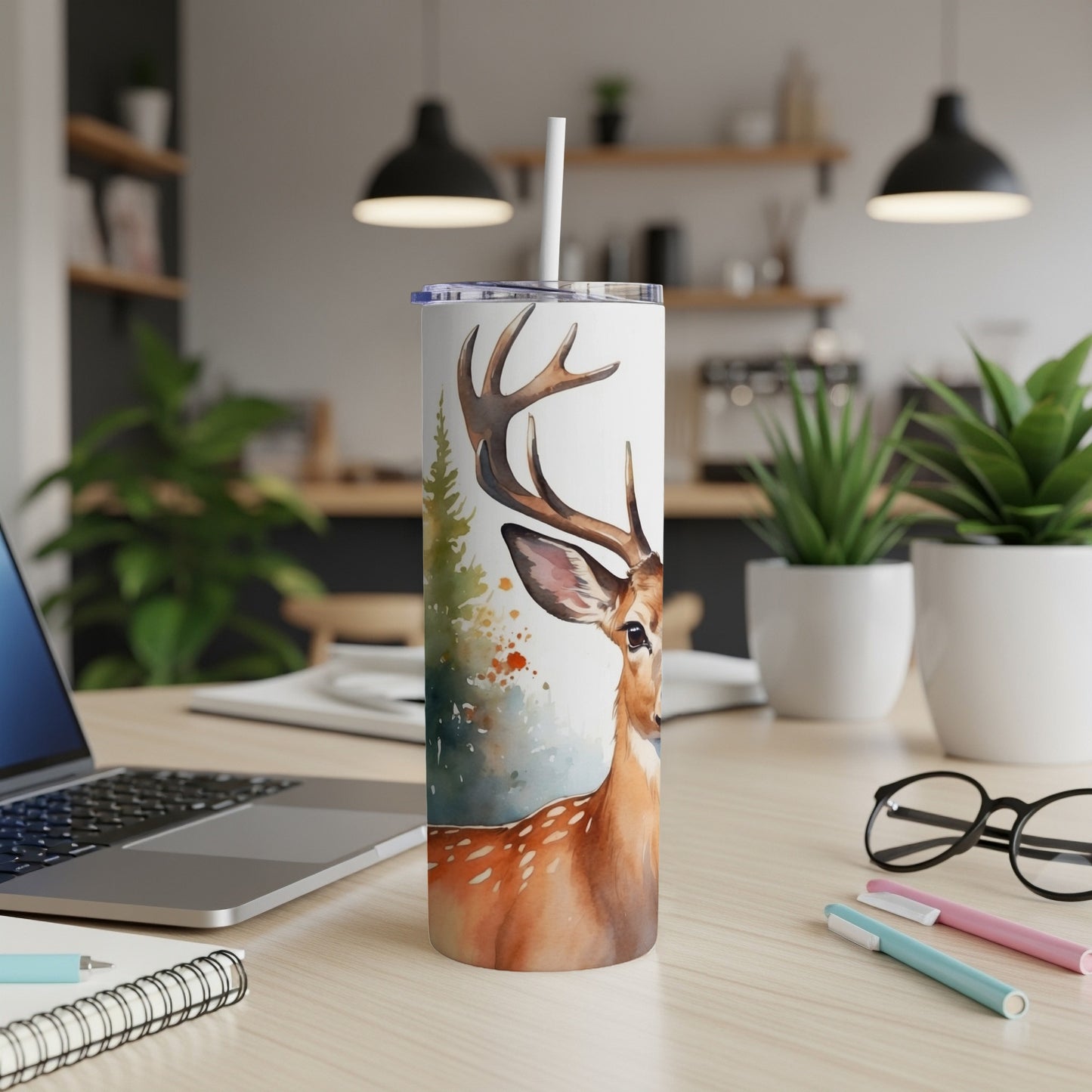Deer and evergreen trees watercolor print on a white insulated tumbler.