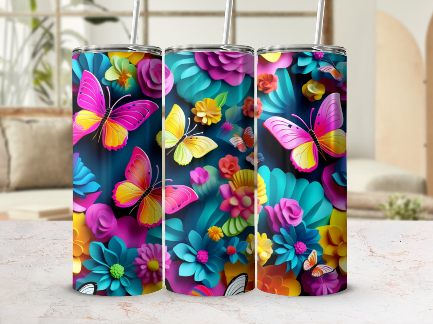 Three tumblers with butterflies and colorful floral designs.