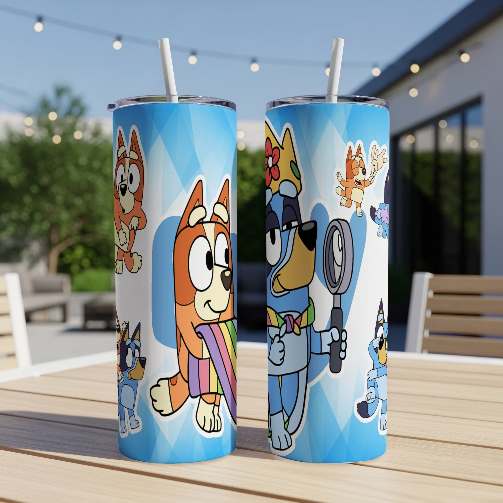 Bluey and Bingo on tumblers with straw, outdoor patio background.