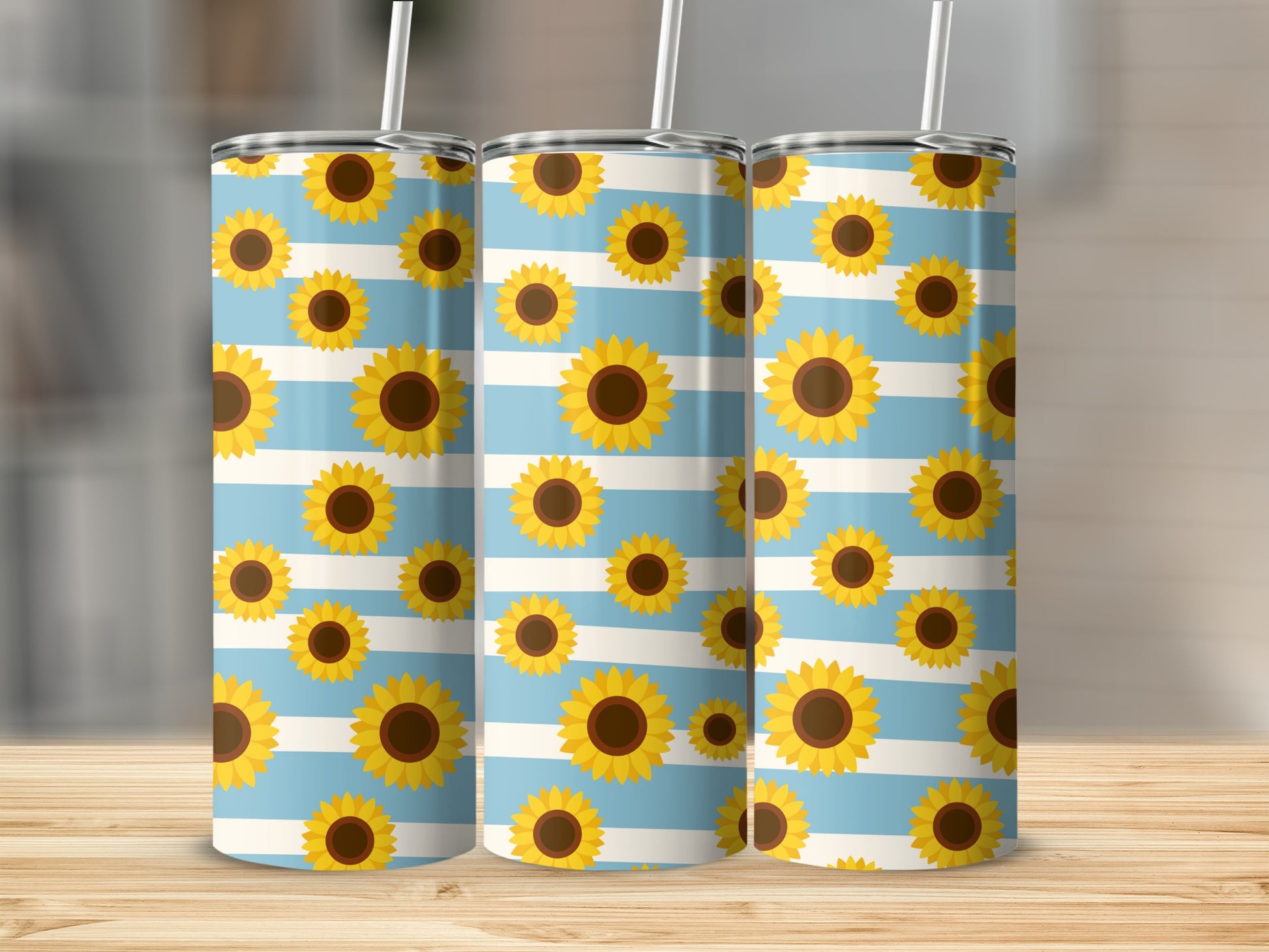 Three tumblers with blue and white stripes and a sunflower pattern.