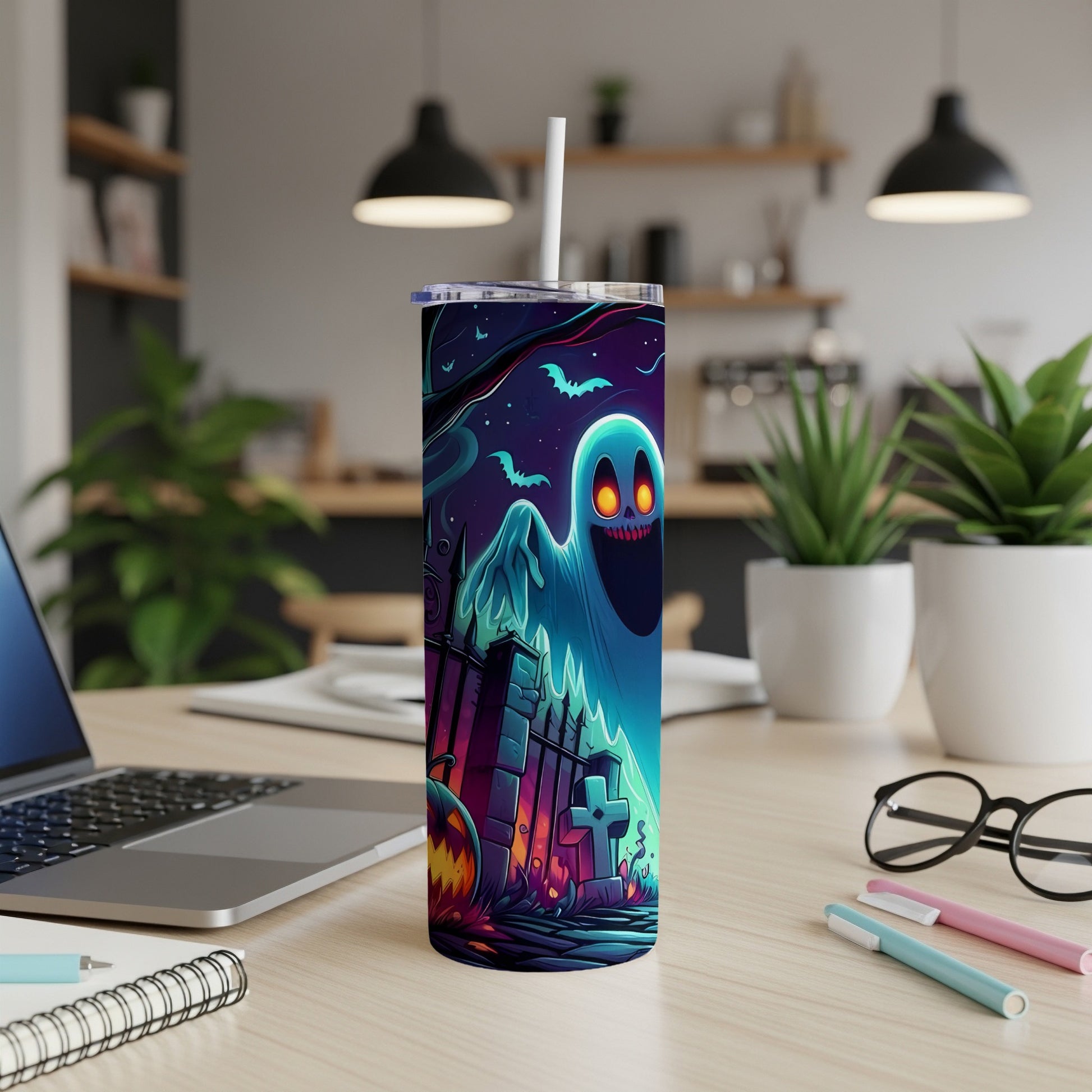Halloween tumbler with a glowing ghost, bats, pumpkin, and graveyard scene.