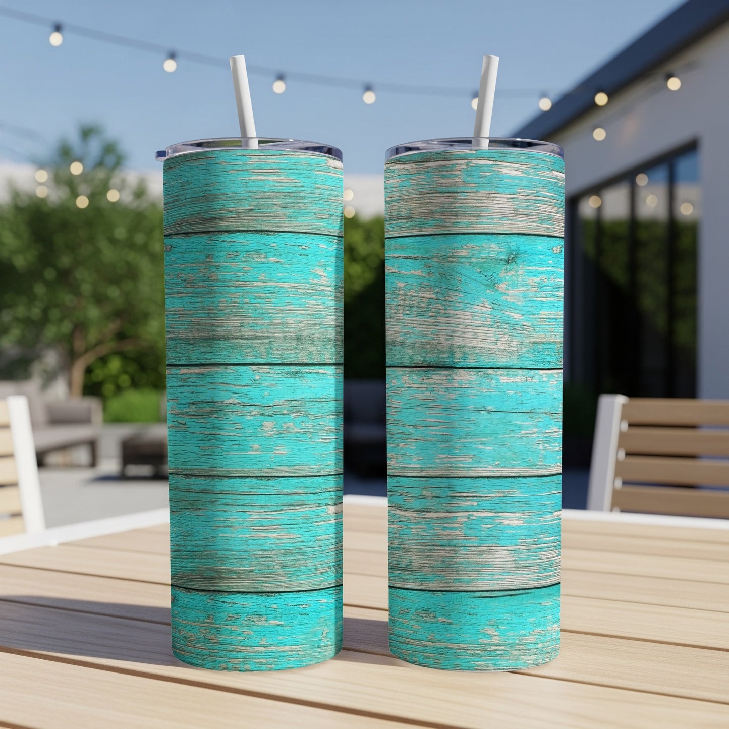 Two tumblers with distressed teal and white wood grain pattern outdoors.