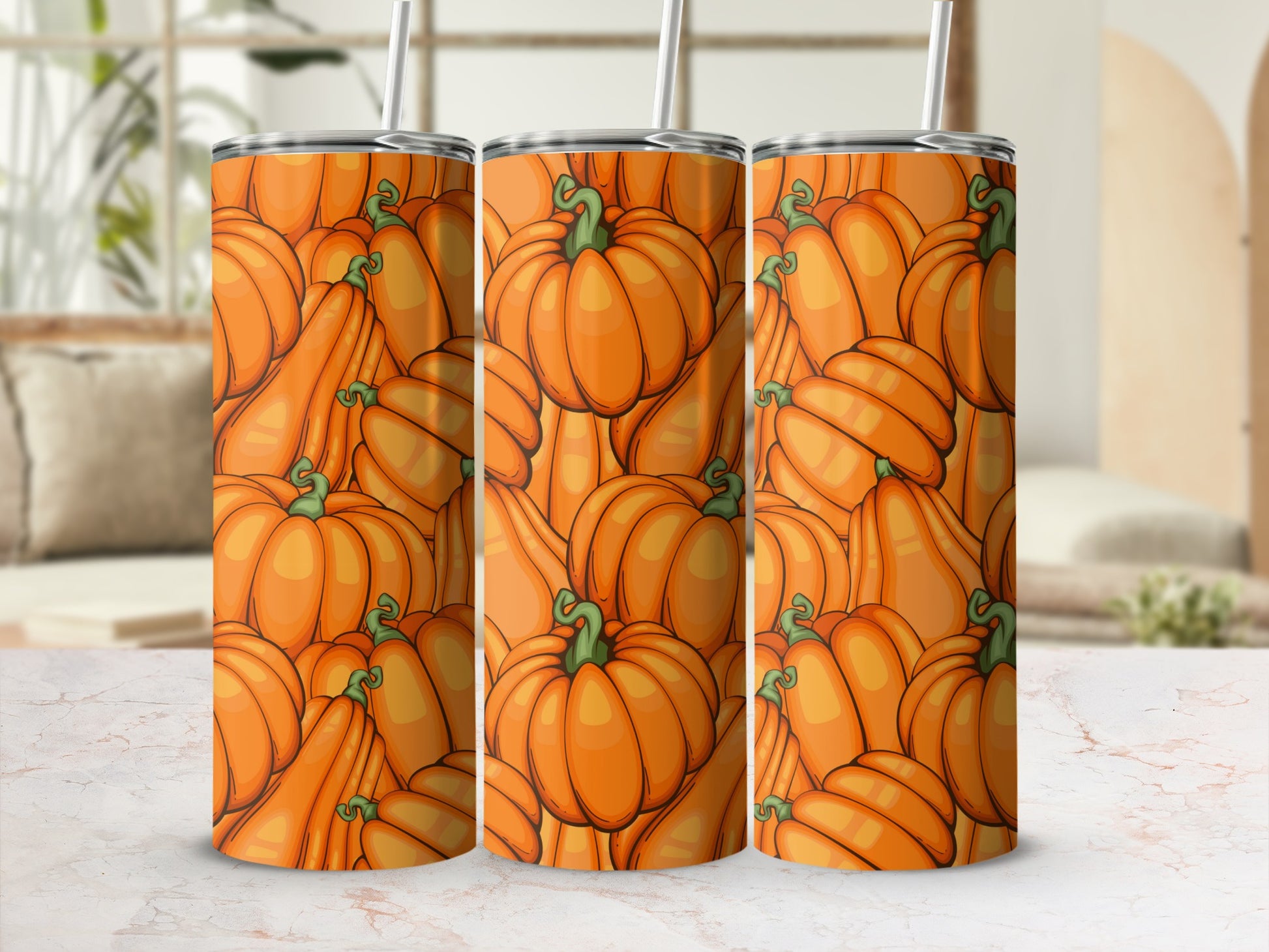 Three tumblers with a repeating pattern of orange pumpkins and green stems.