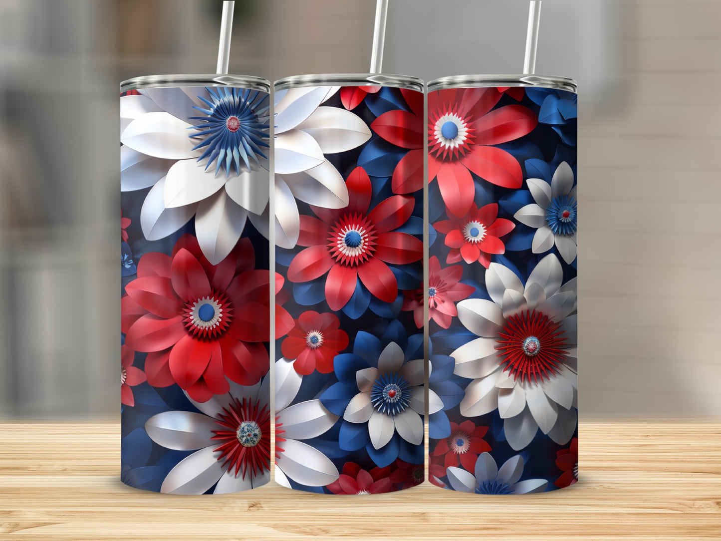 Three tumblers with red, white, and blue floral designs on a wooden surface.