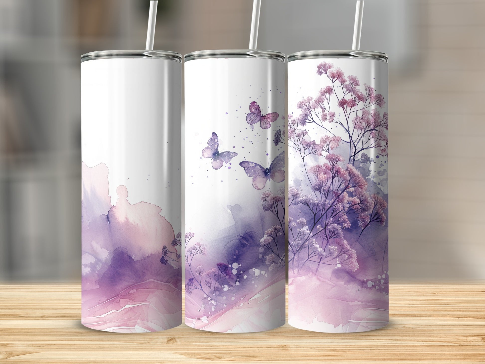 Three tumblers with watercolor butterfly and floral designs in purple and pink.