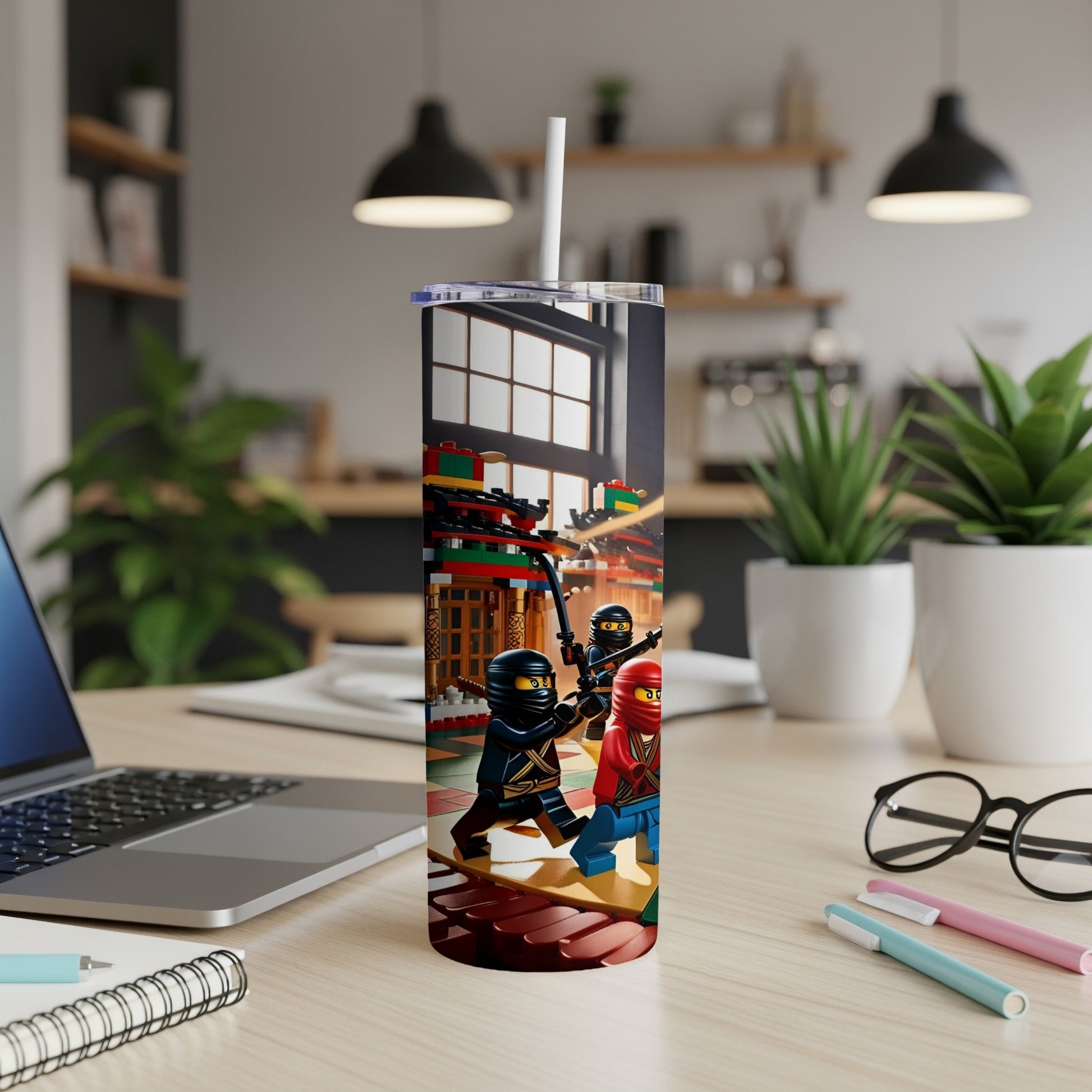 Ninjago minifigures on a bridge, with a laptop and pens in the foreground.
