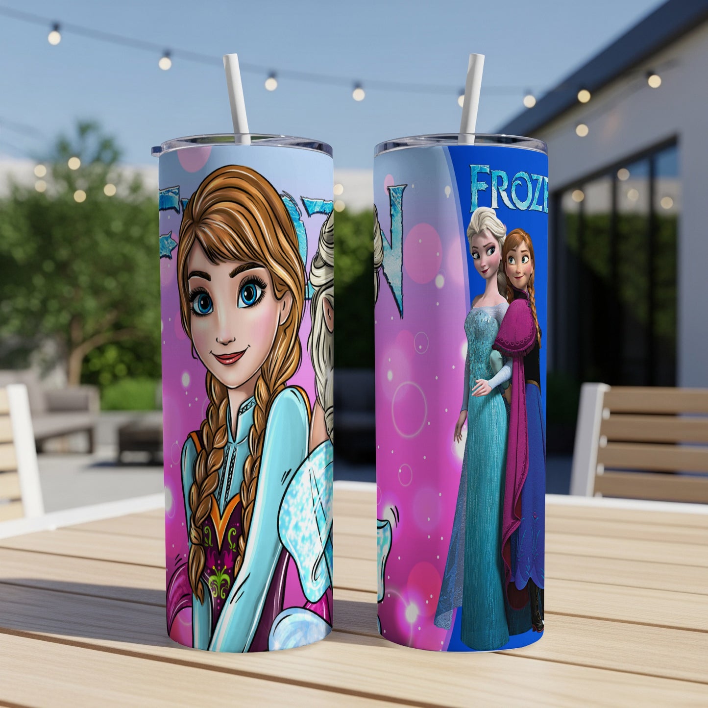 Two Frozen tumblers with Elsa and Anna on a wooden table.