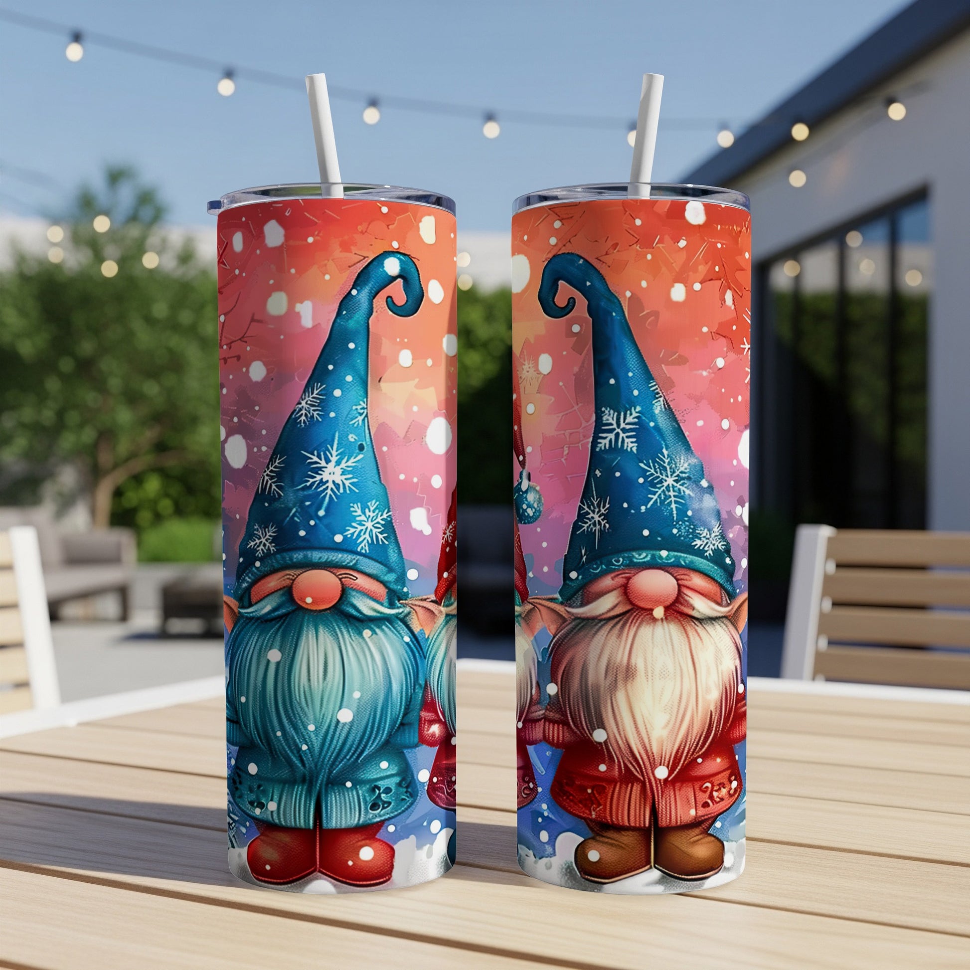 Two gnome tumblers with blue hats, snowflakes, and colorful backgrounds.
