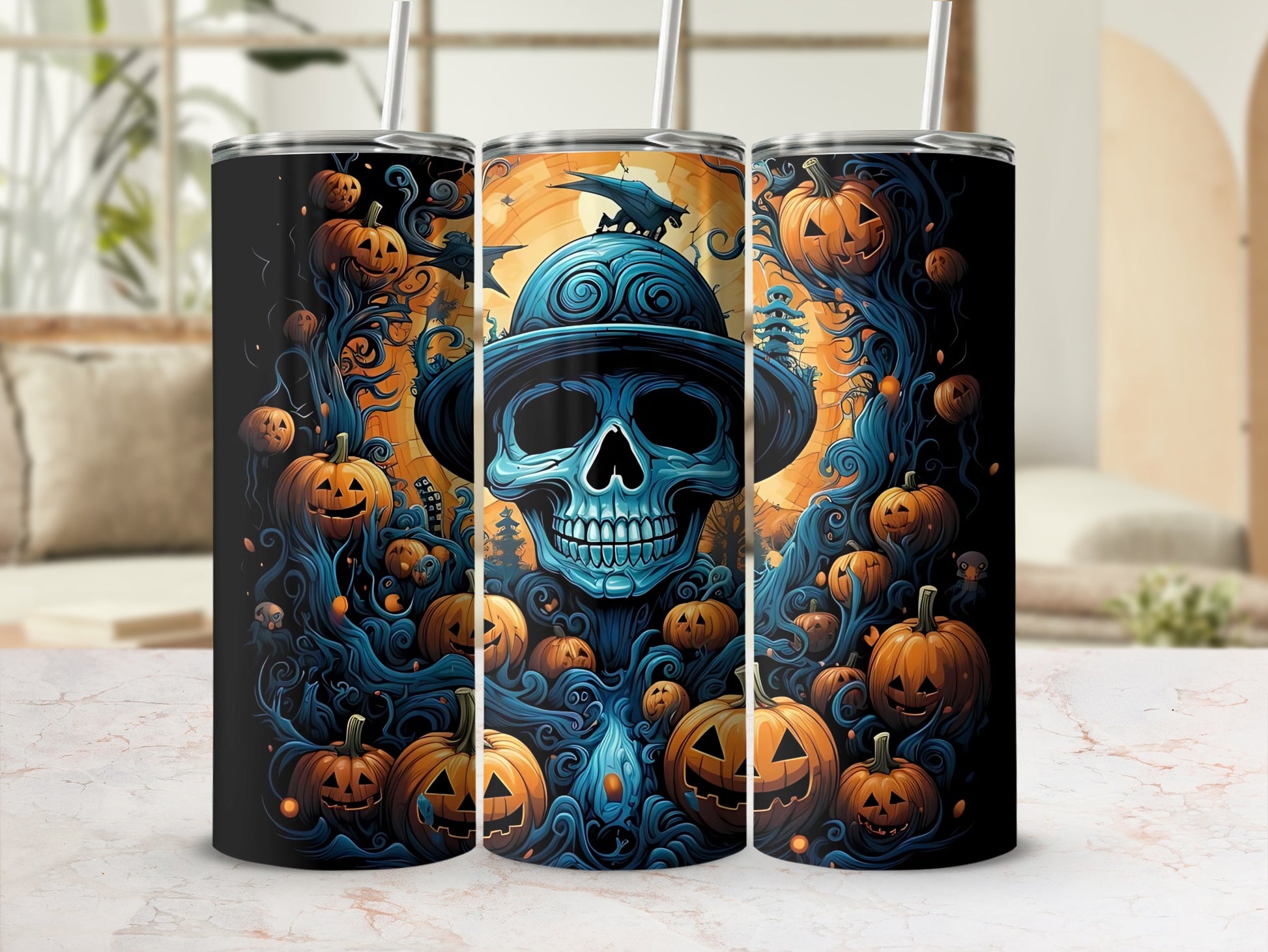 Tumblers featuring a Halloween theme with a blue skull wearing a hat, pumpkins, and spooky trees.