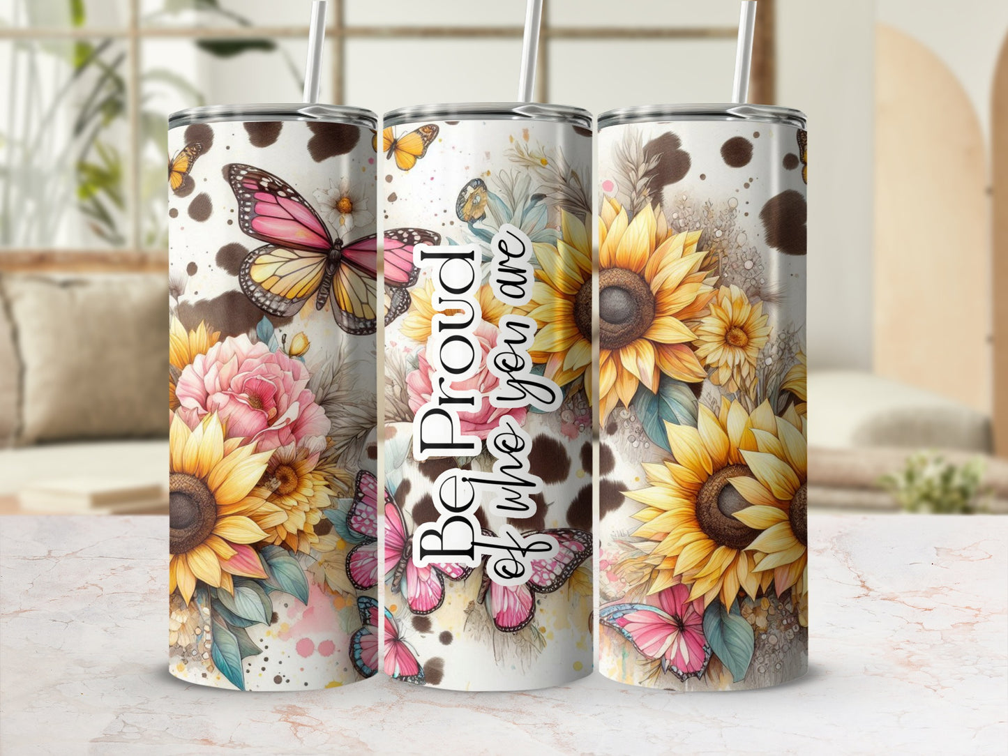 Sunflower, butterfly, and cow print tumbler with text "Be Proud of Who You Are".