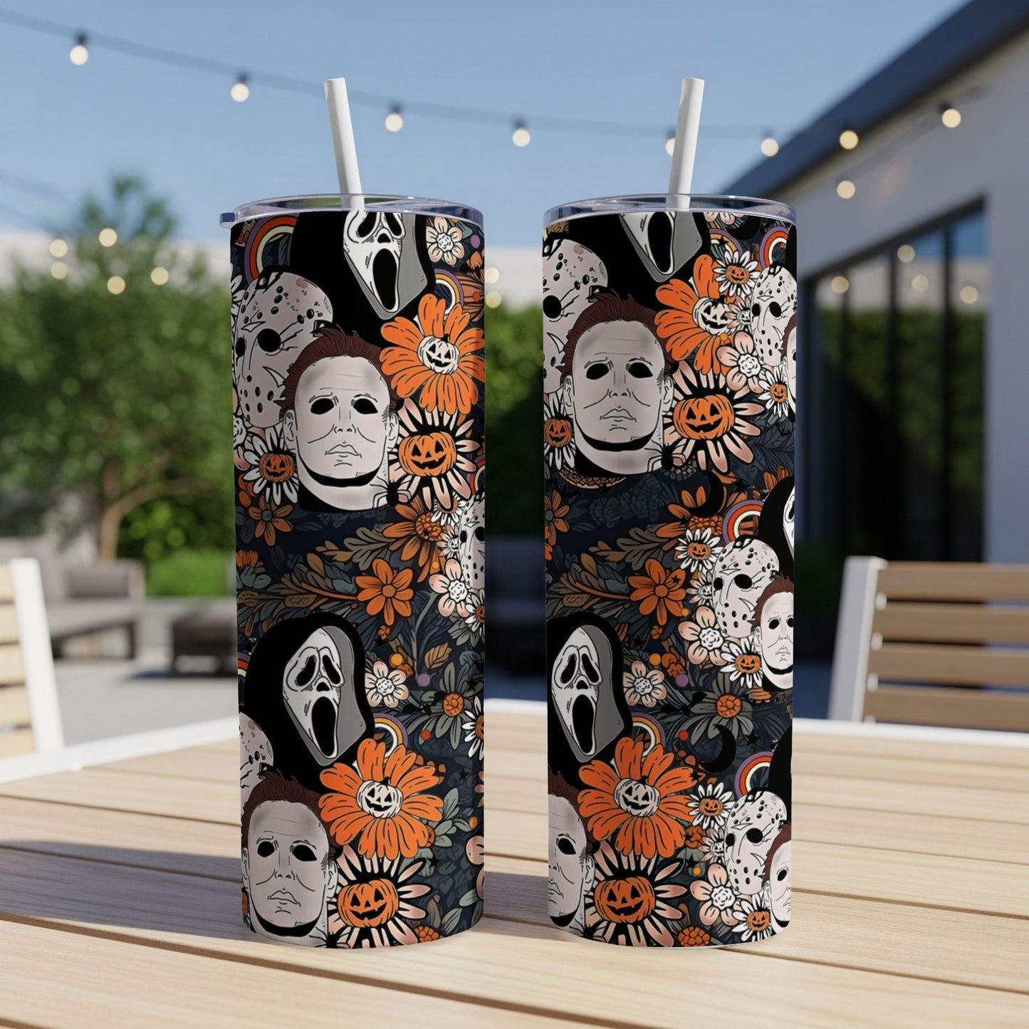Halloween themed tumbler with horror movie characters and floral print.