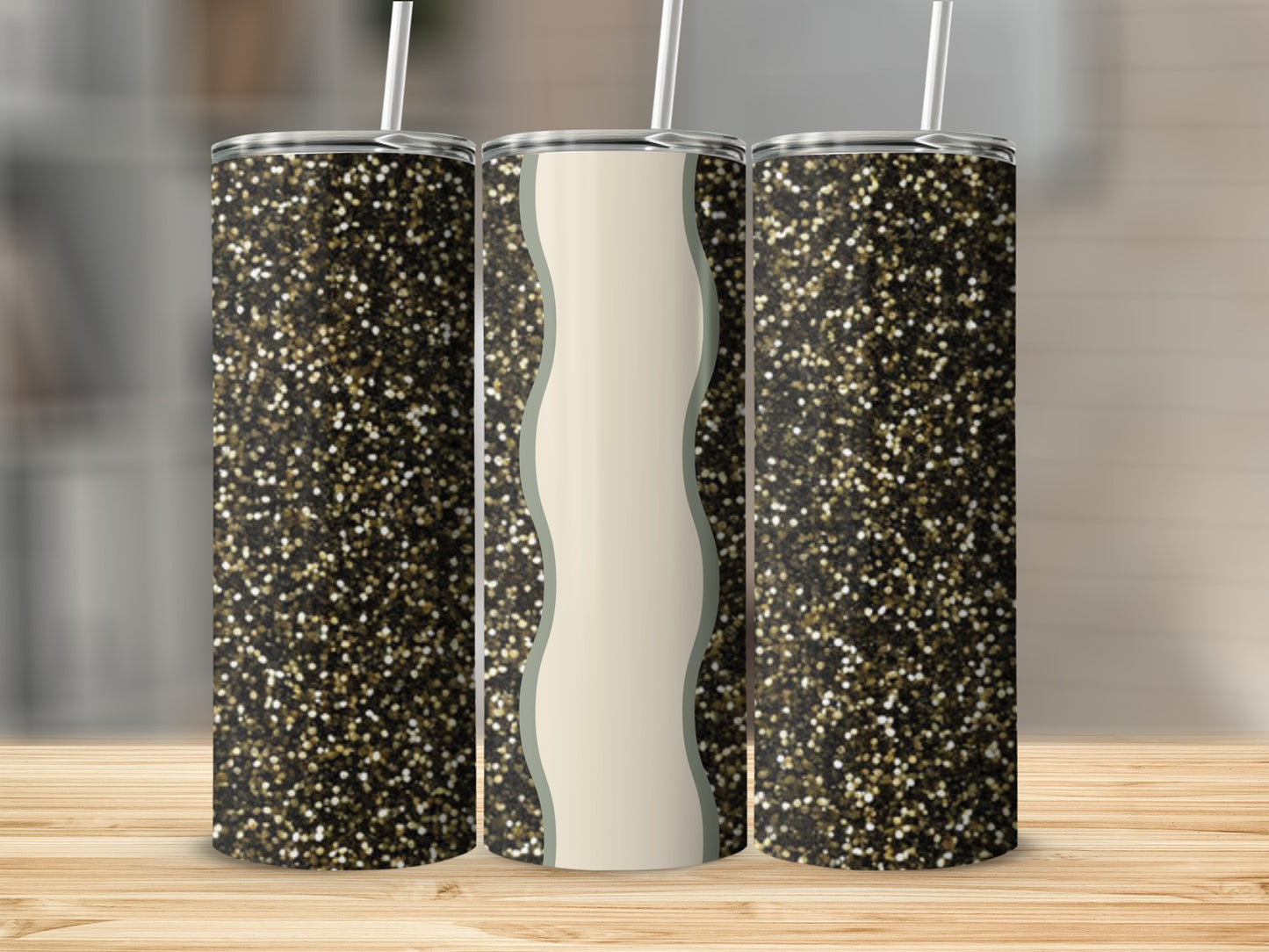 Three glitter tumblers with straws on a wooden surface.