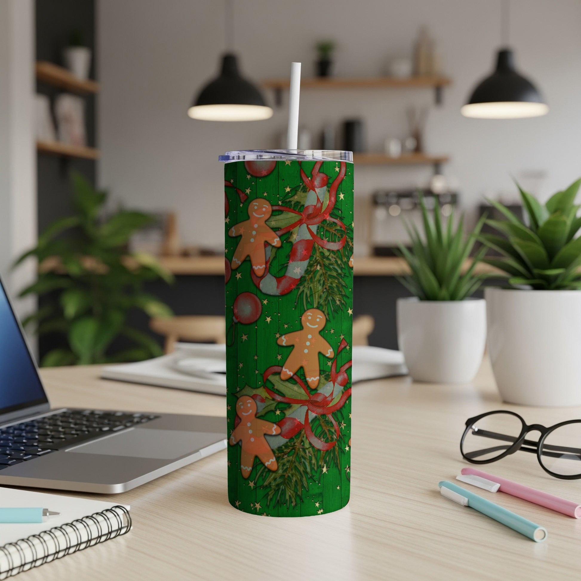 Green tumbler with gingerbread men, candy canes, and holly pattern.