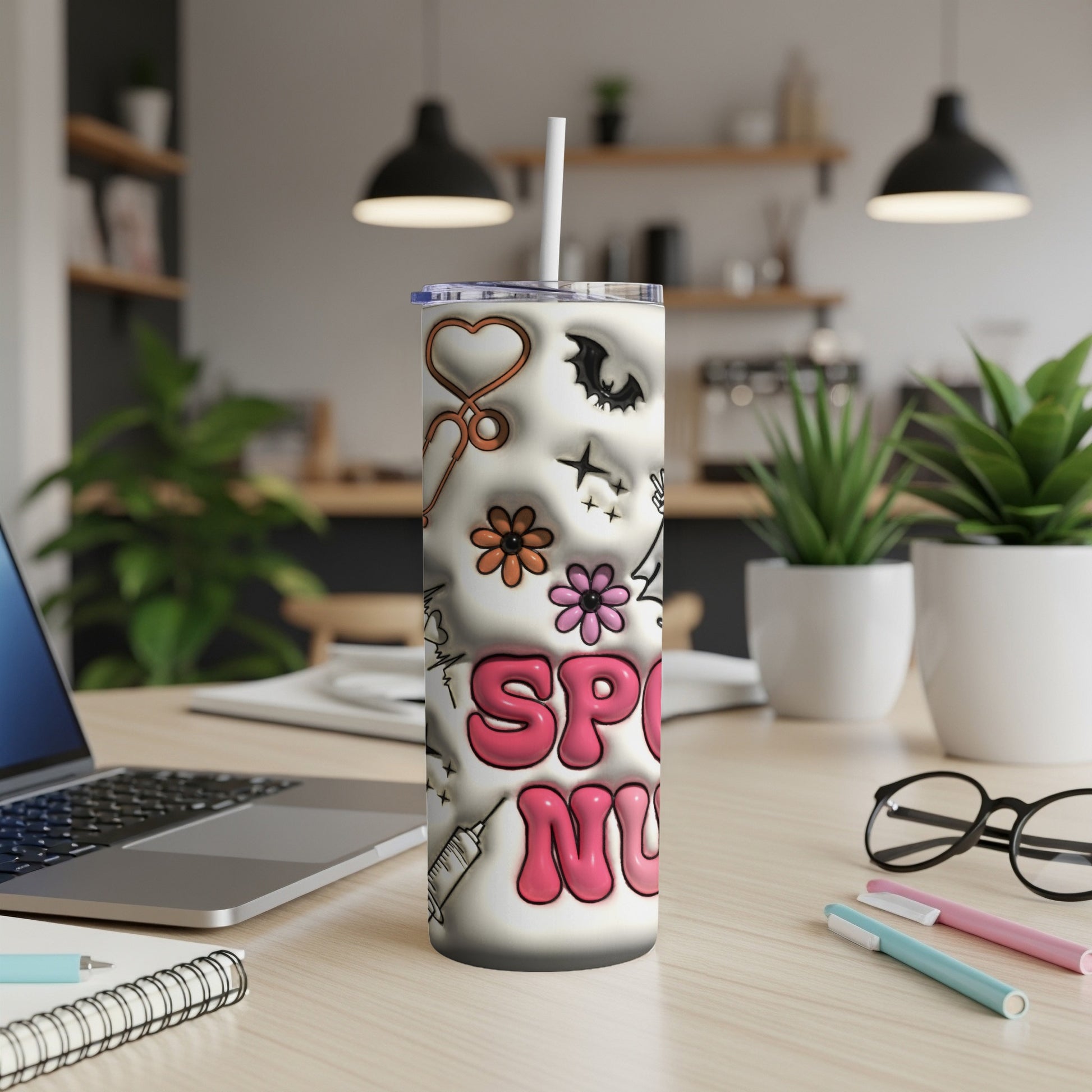 White tumbler with nurse-themed doodles, "Spooky Nurse" text, on desk.