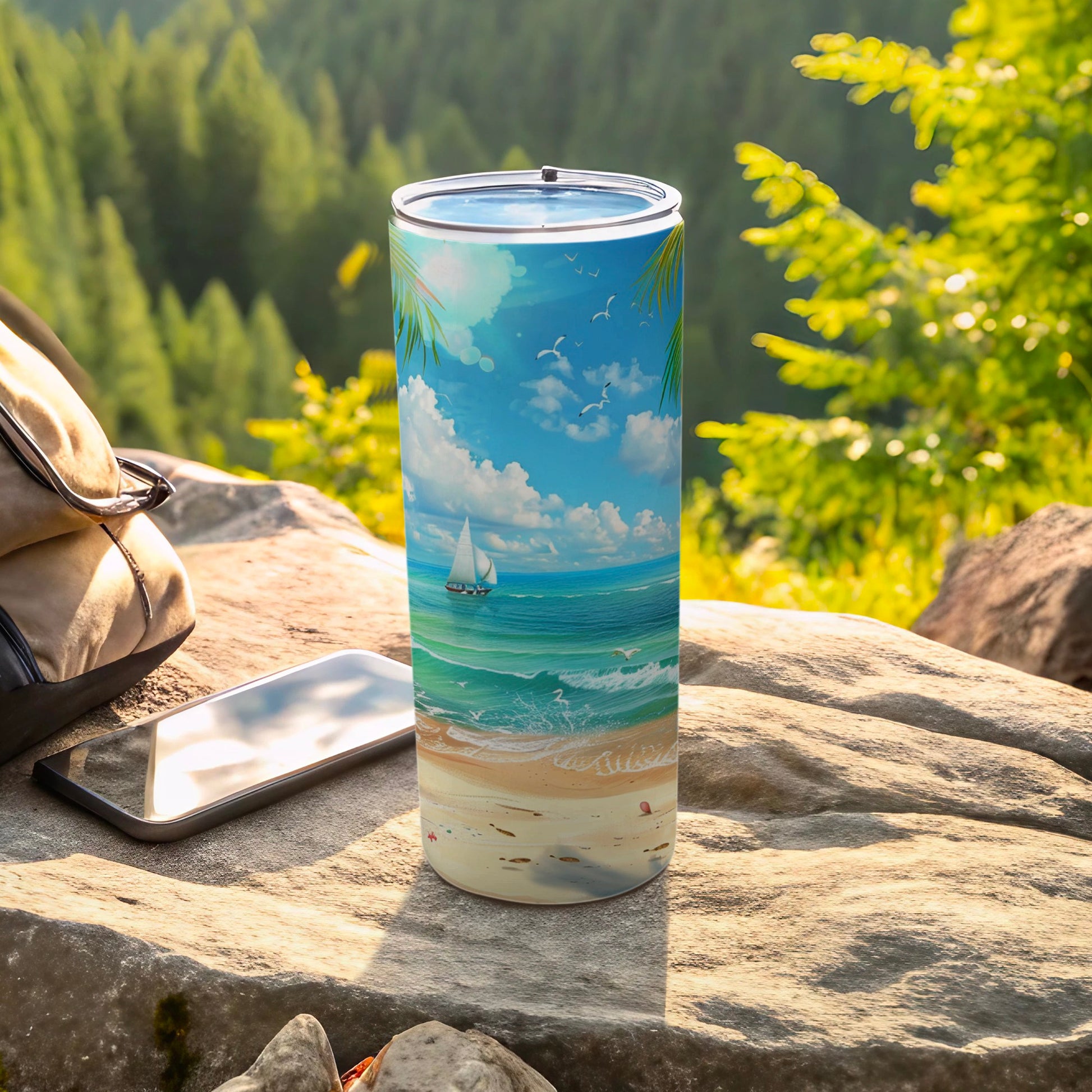 Tall tumbler with sailboat and beach scene on a rocky outcrop.