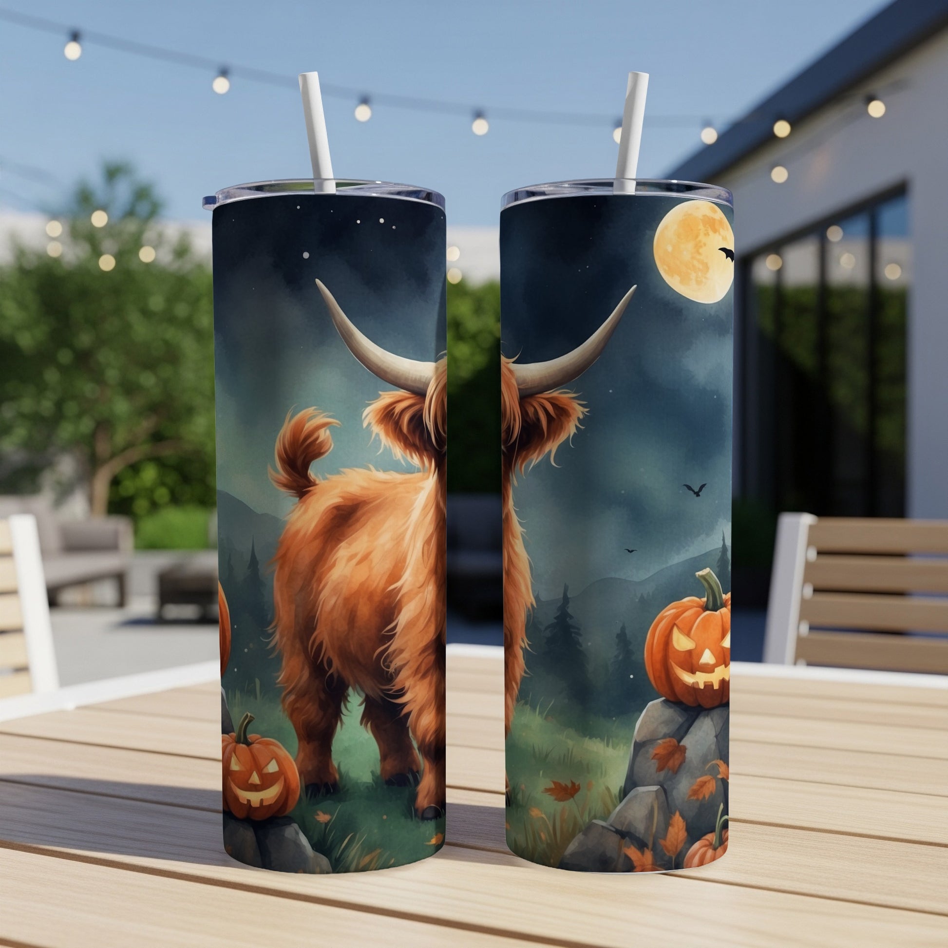 Highland cow and pumpkins on a tumbler with a nighttime Halloween scene.