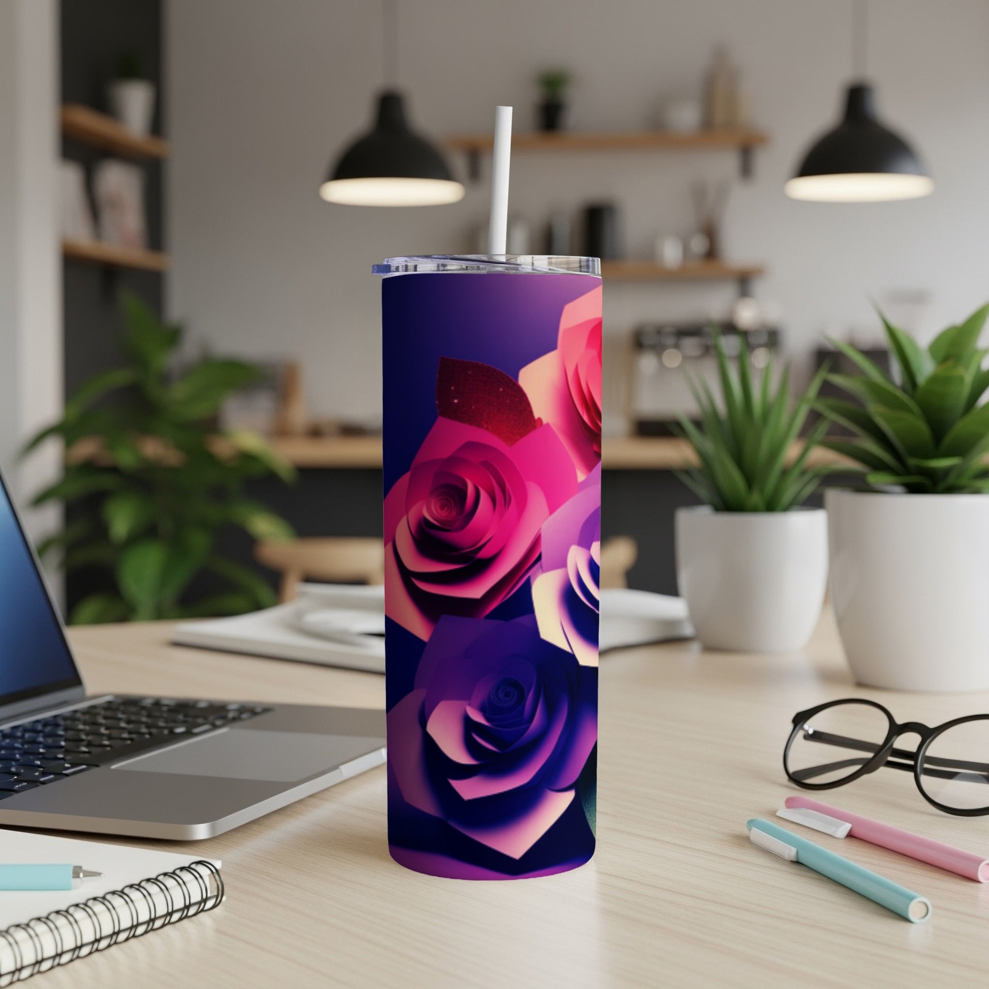 Pink and purple roses adorn a dark gradient tumbler with a straw.